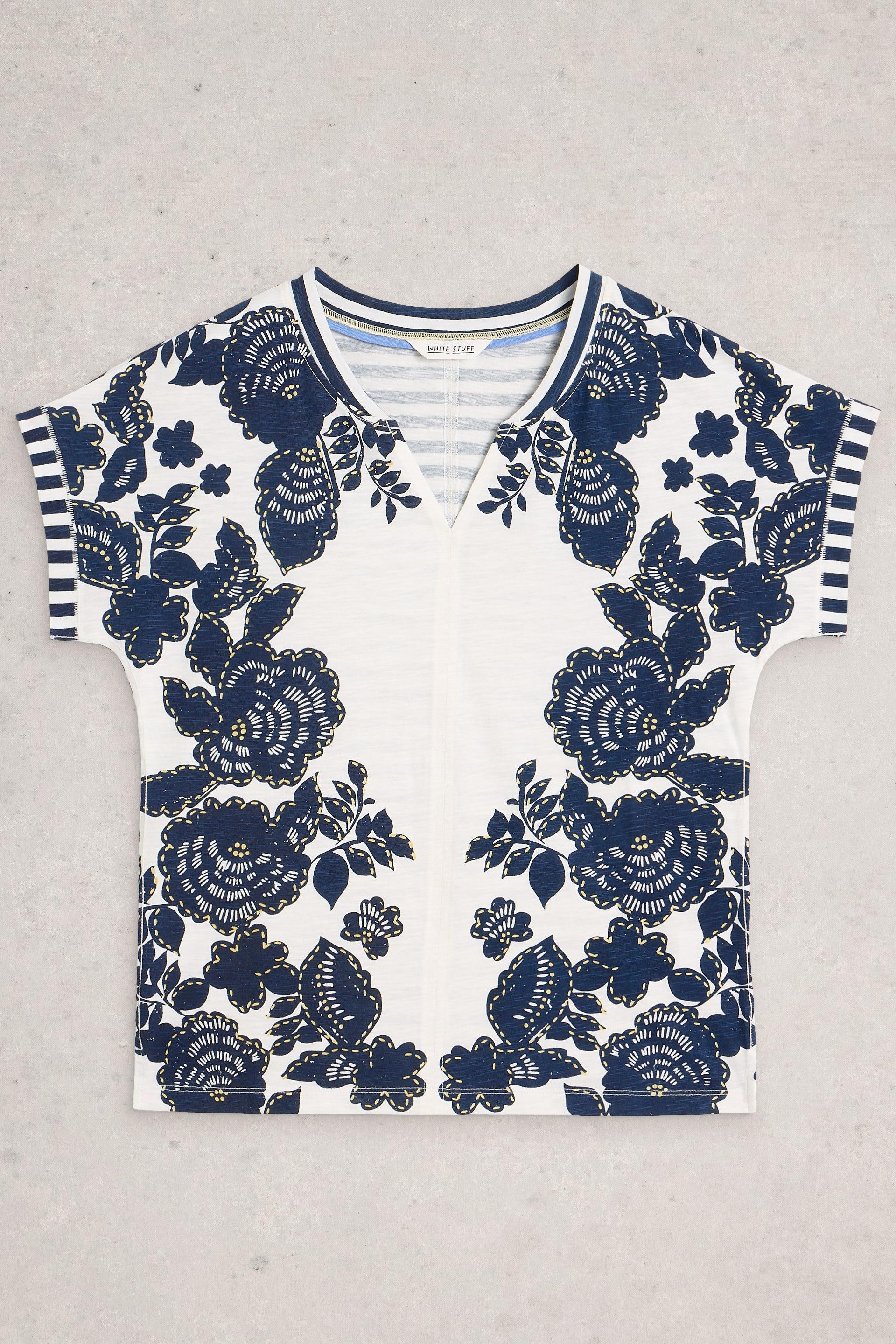 White Stuff t-shirt with blue floral patterns on a gray background