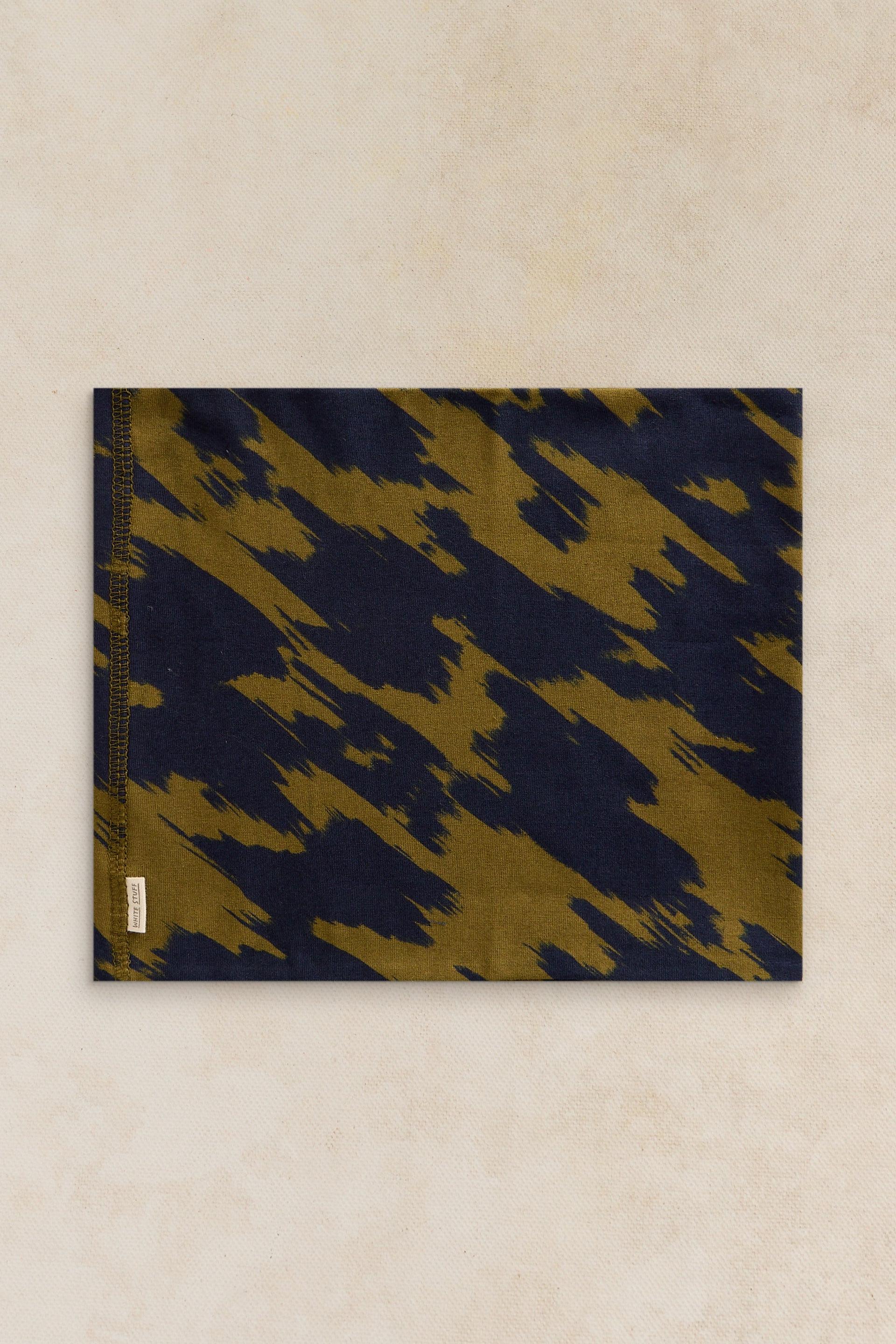 A rectangular neck warmer featuring an abstract olive and navy brushstroke pattern on a light textured background