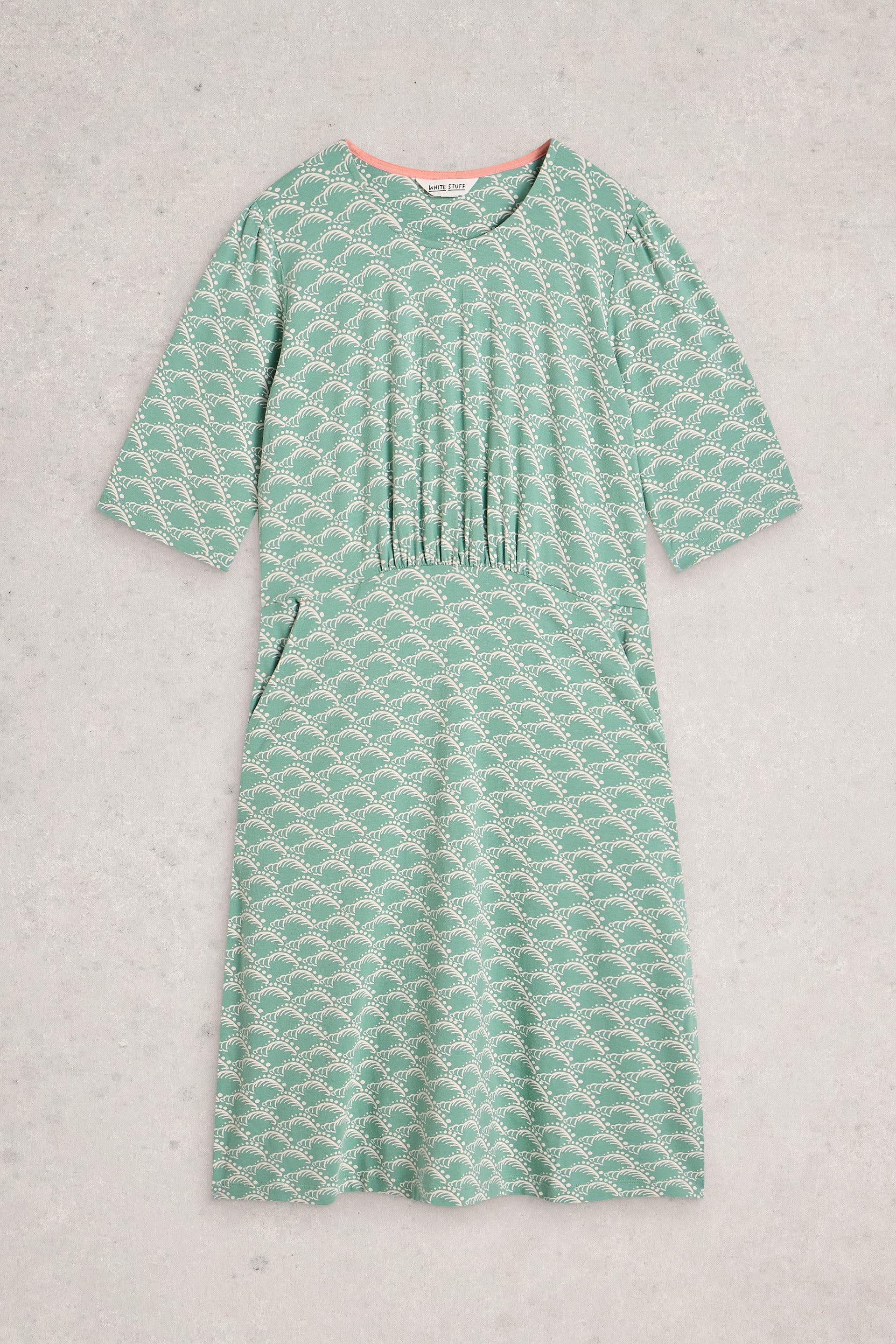Green organic cotton dress on a light gray background