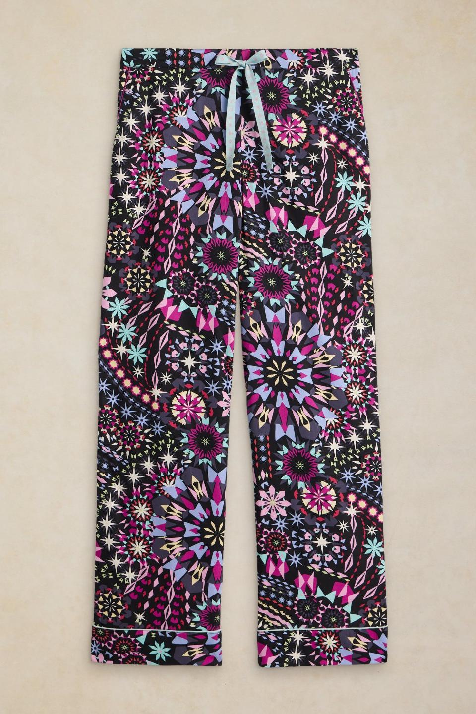 White Stuff organic cotton pyjama bottoms featuring a colourful black-based geometric print and drawstring waist.