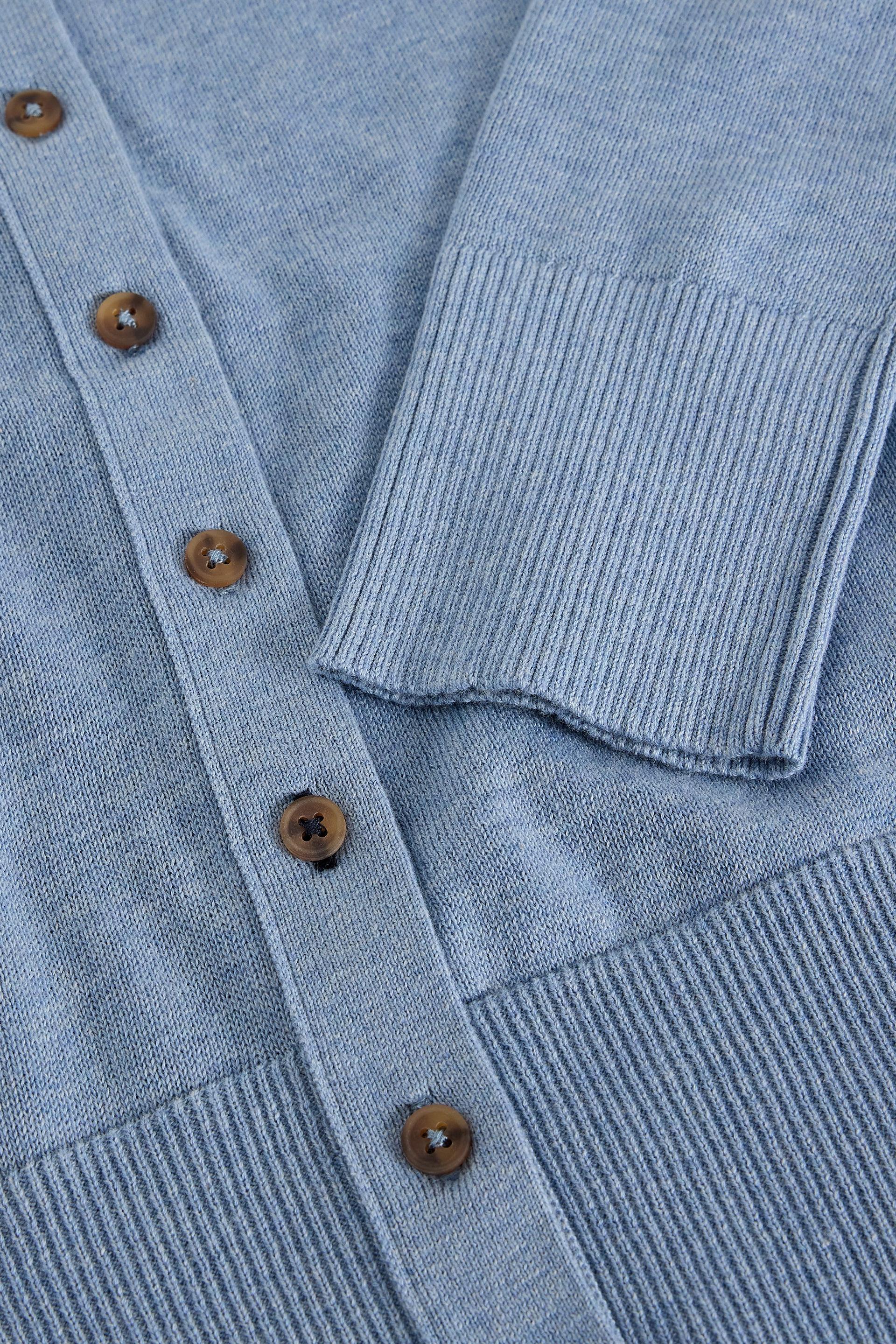 Close up of a blue organic cotton cardigan with brown buttons by White Stuff