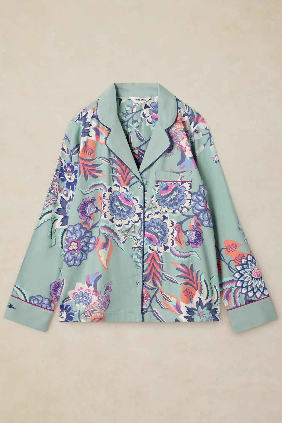 White Stuff organic cotton pyjama top featuring a blue floral print against a mint green background.