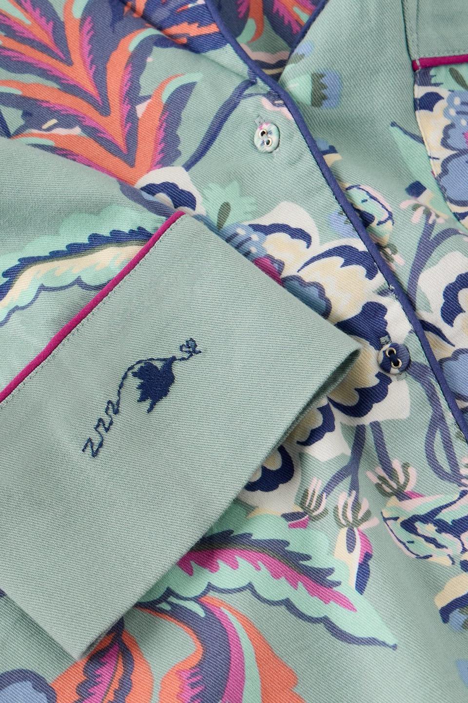 Close-up of a White Stuff organic cotton pyjama top featuring a blue floral print and piped detailing.
