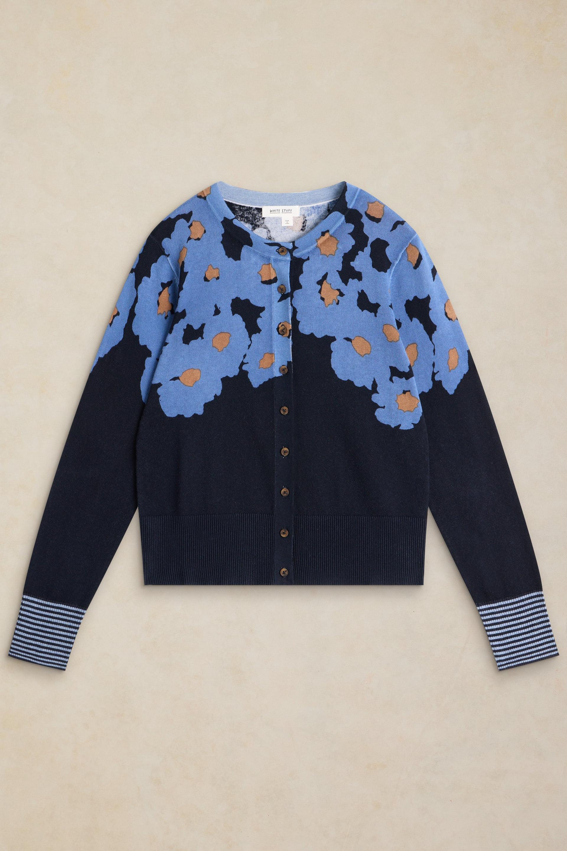 A White Stuff organic cotton cardigan with a blue and navy floral pattern against a light background