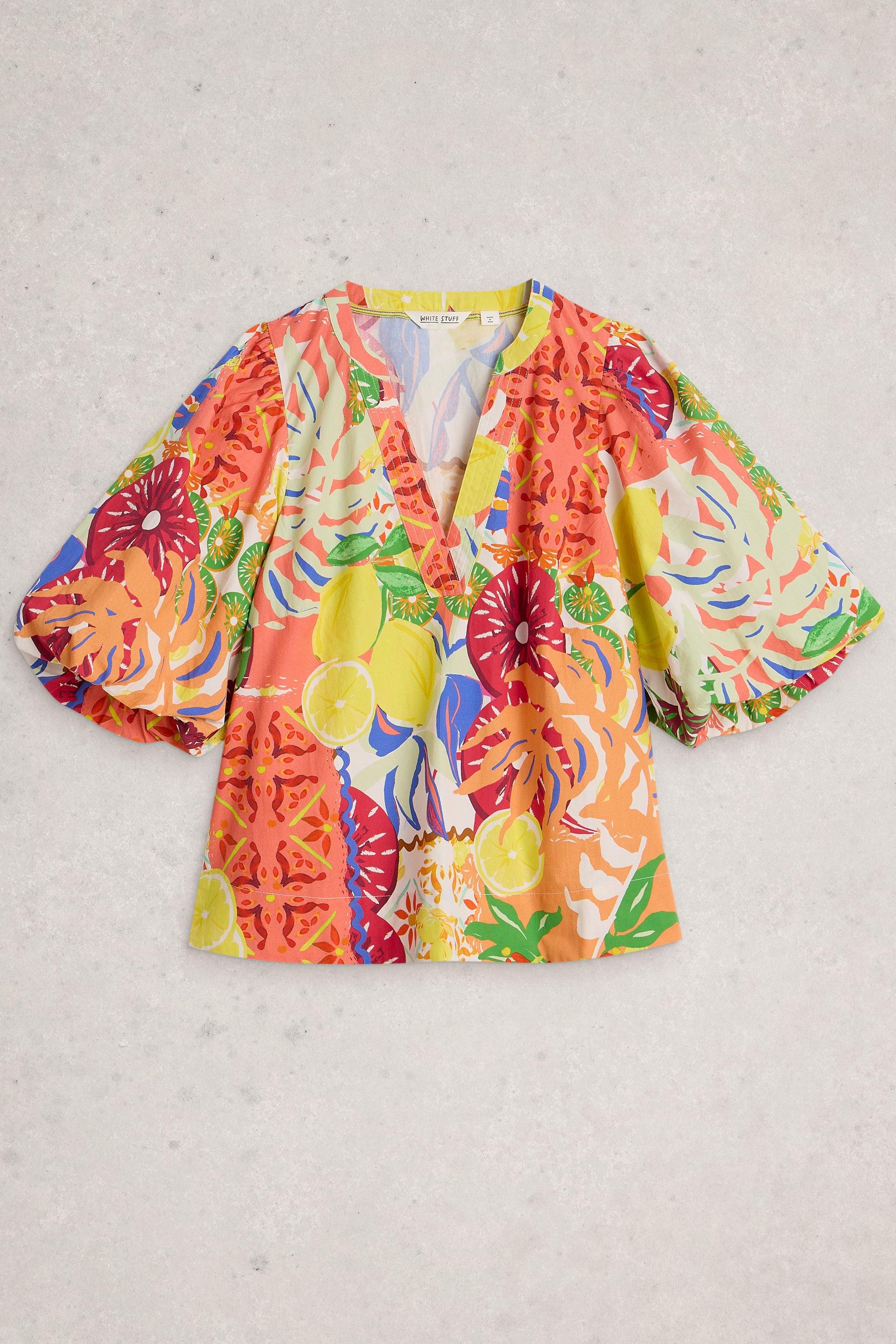 White Stuff organic cotton blouse featuring a coluorful citrus and floral pattern with short puff sleeves.