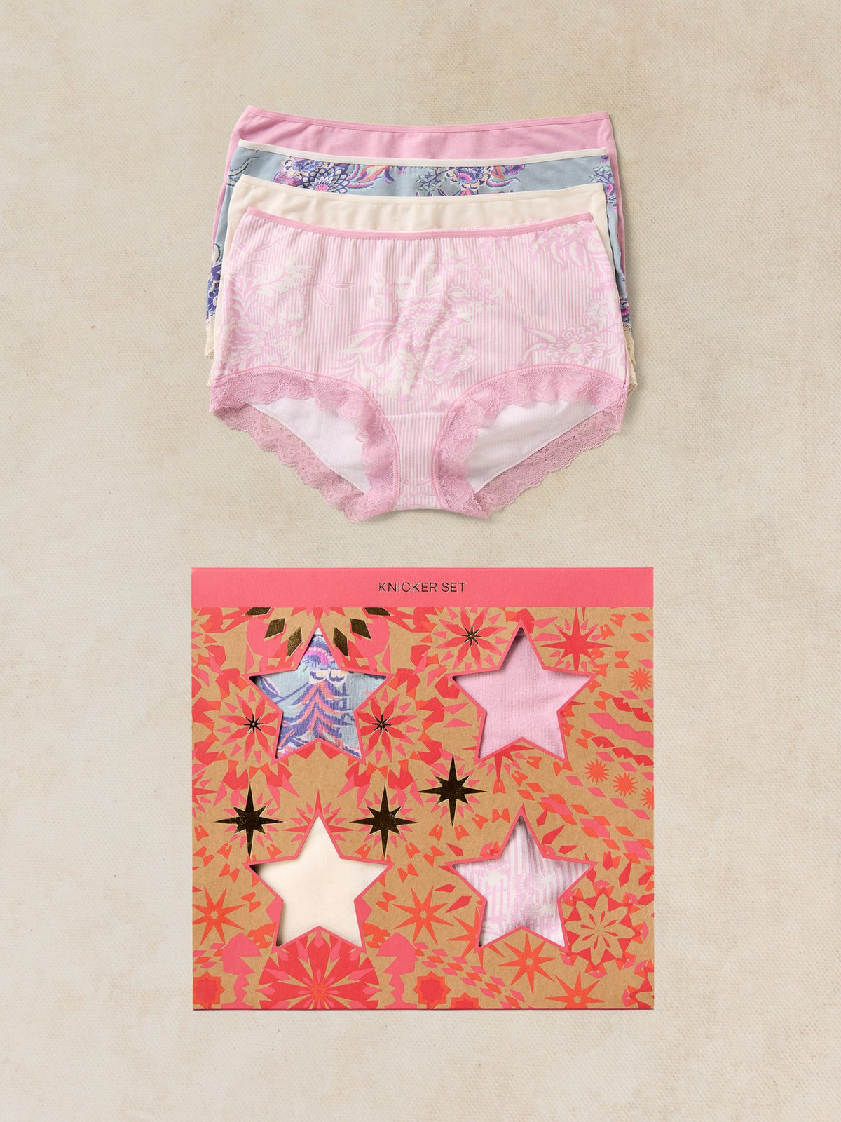 A multi-pack of women's organic cotton underwear by White Stuff, shown with its star-themed cardboard gift box.