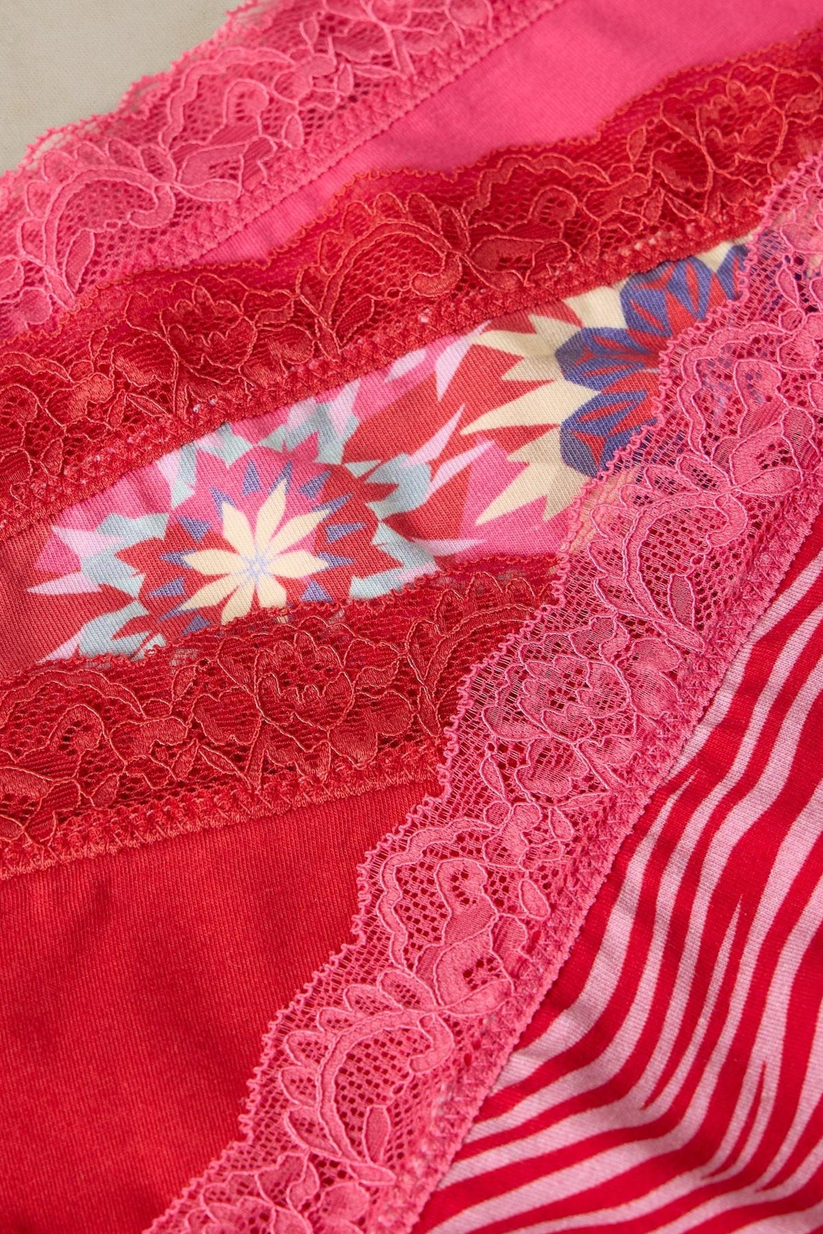 Close up of folded White Stuff organic cotton women's underwear with lace trim and patterns