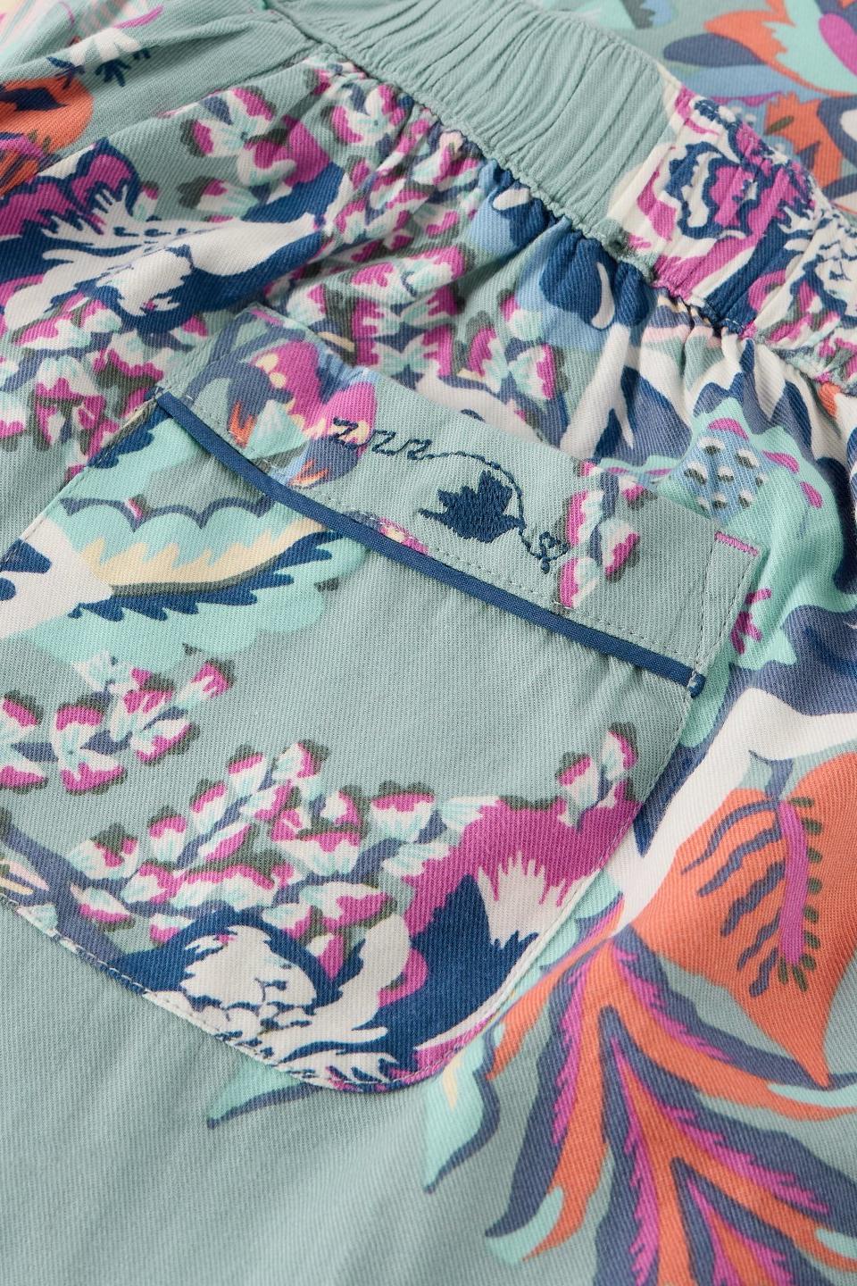 Close-up of White Stuff organic cotton pyjama bottoms with a blue floral print and a small pocket.