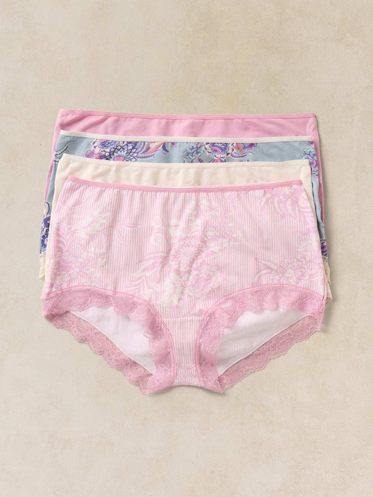 A stack of White Stuff organic cotton women's knickers in assorted floral and striped patterns.