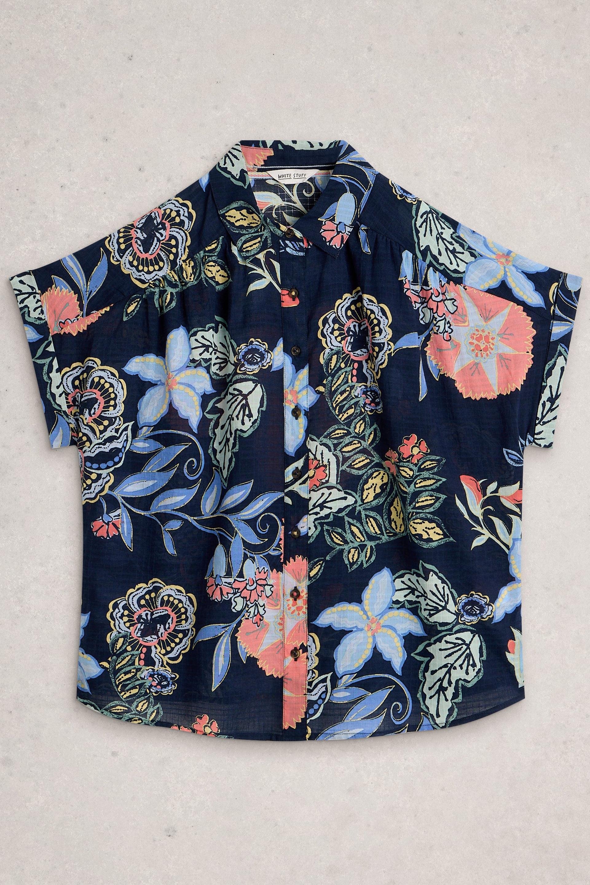 Navy blue organic cotton shirt with colourful floral pattern on a light gray background