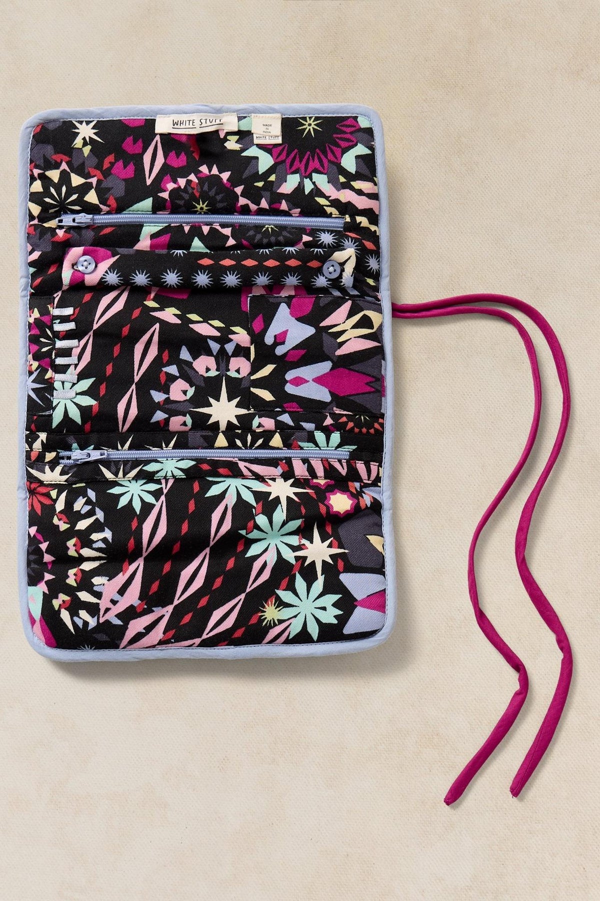 White Stuff floral patterned roll-up jewellery organiser with zip pockets and pink tie strings.