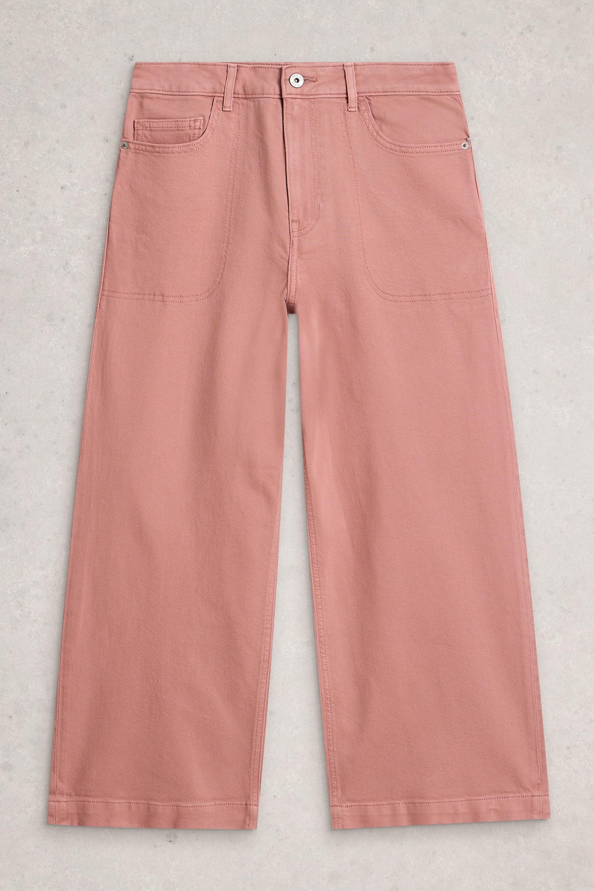 Wide-leg pink trousers made of organic cotton from White Stuff on a light textured background.