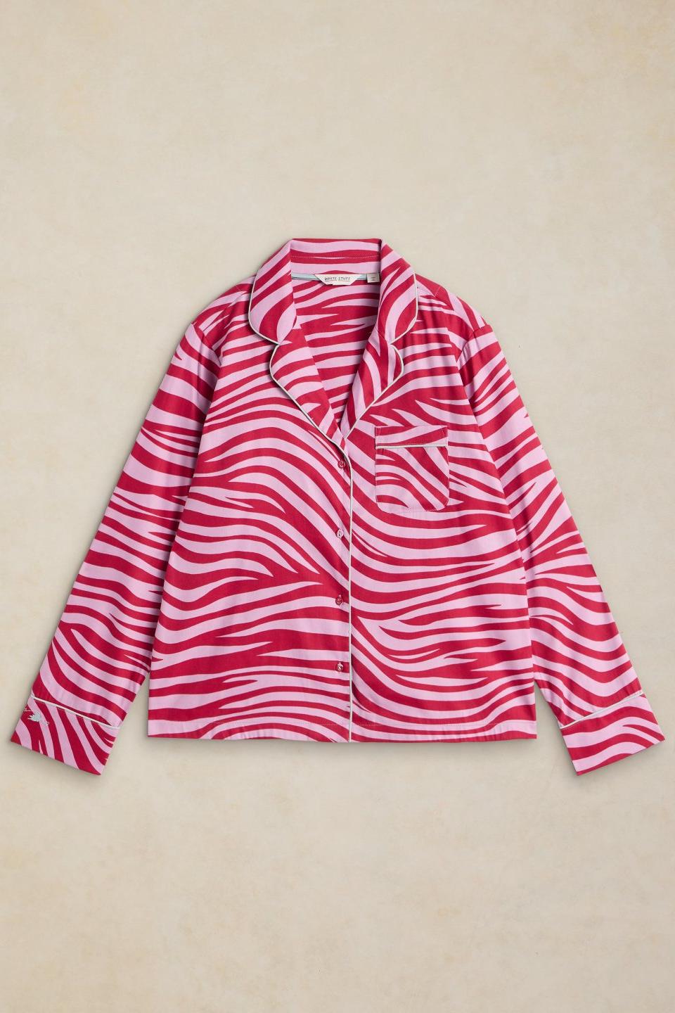 White Stuff pink zebra print organic cotton pyjama top with long sleeves and button front closure.
