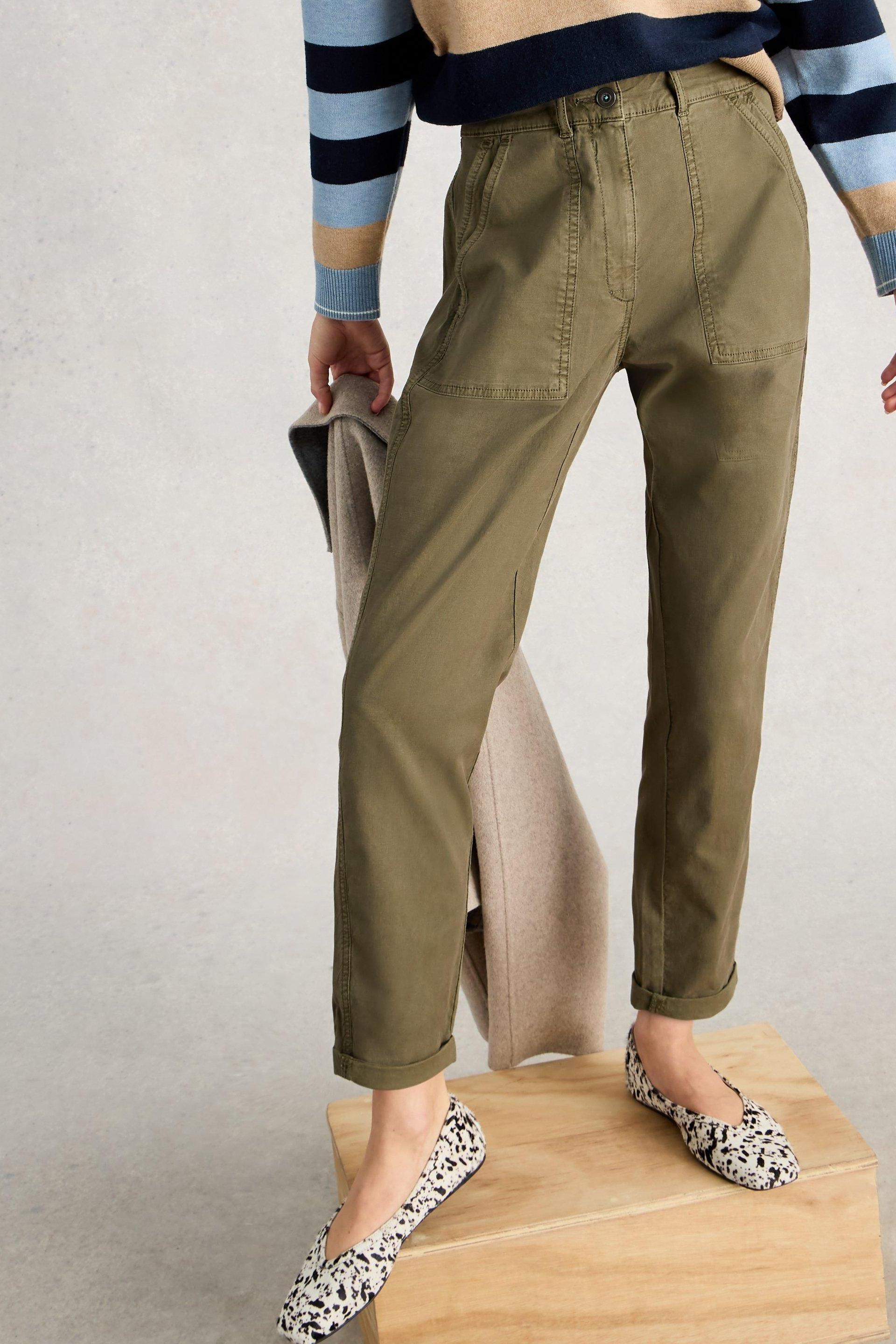 Woman wearing White Stuff khaki twister chinos and animal print flats