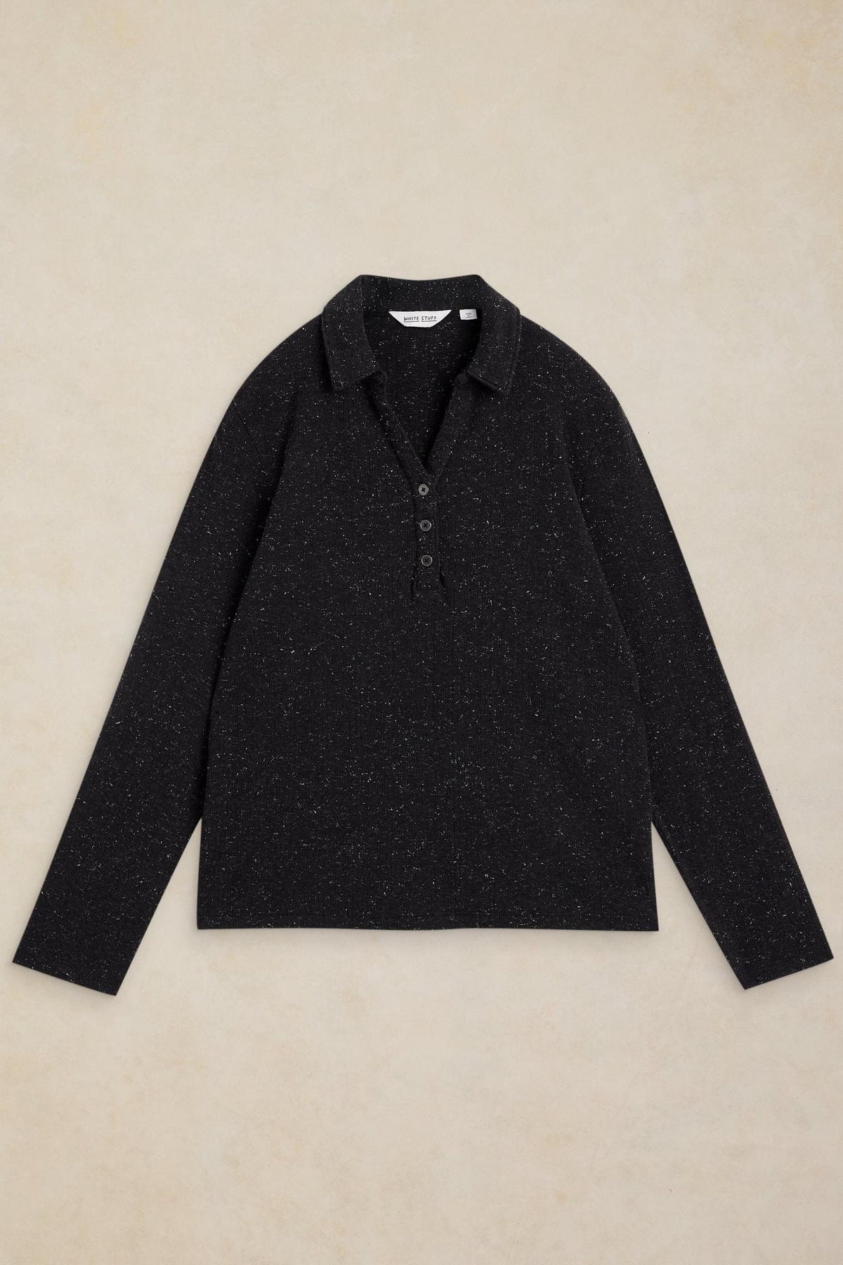 A black long-sleeve White Stuff polo top with subtle sparkle detail on a neutral background.