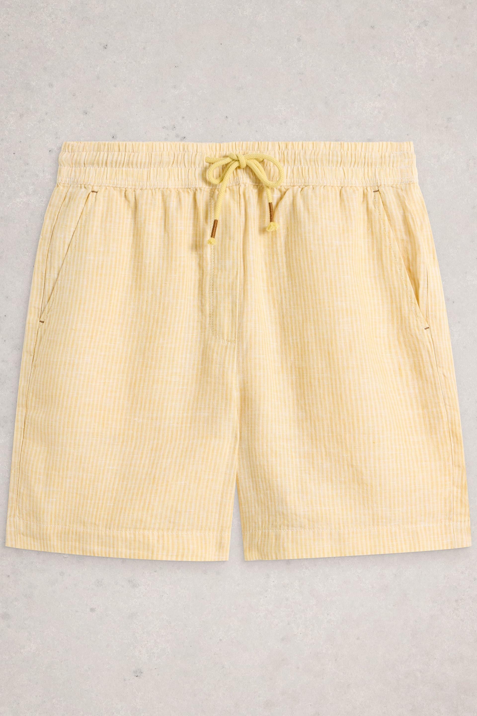 Yellow striped shorts on a light gray background