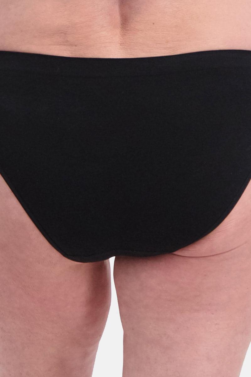 Rear view of a woman wearing black bamboo fabric briefs against a white background