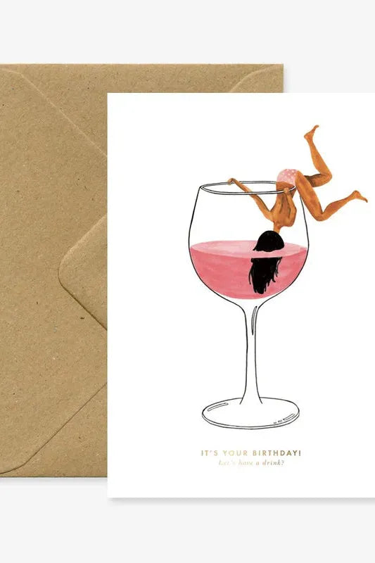Greeting card with a wine glass illustration and 'Happy Birthday' text, accompanied by a brown envelope.
