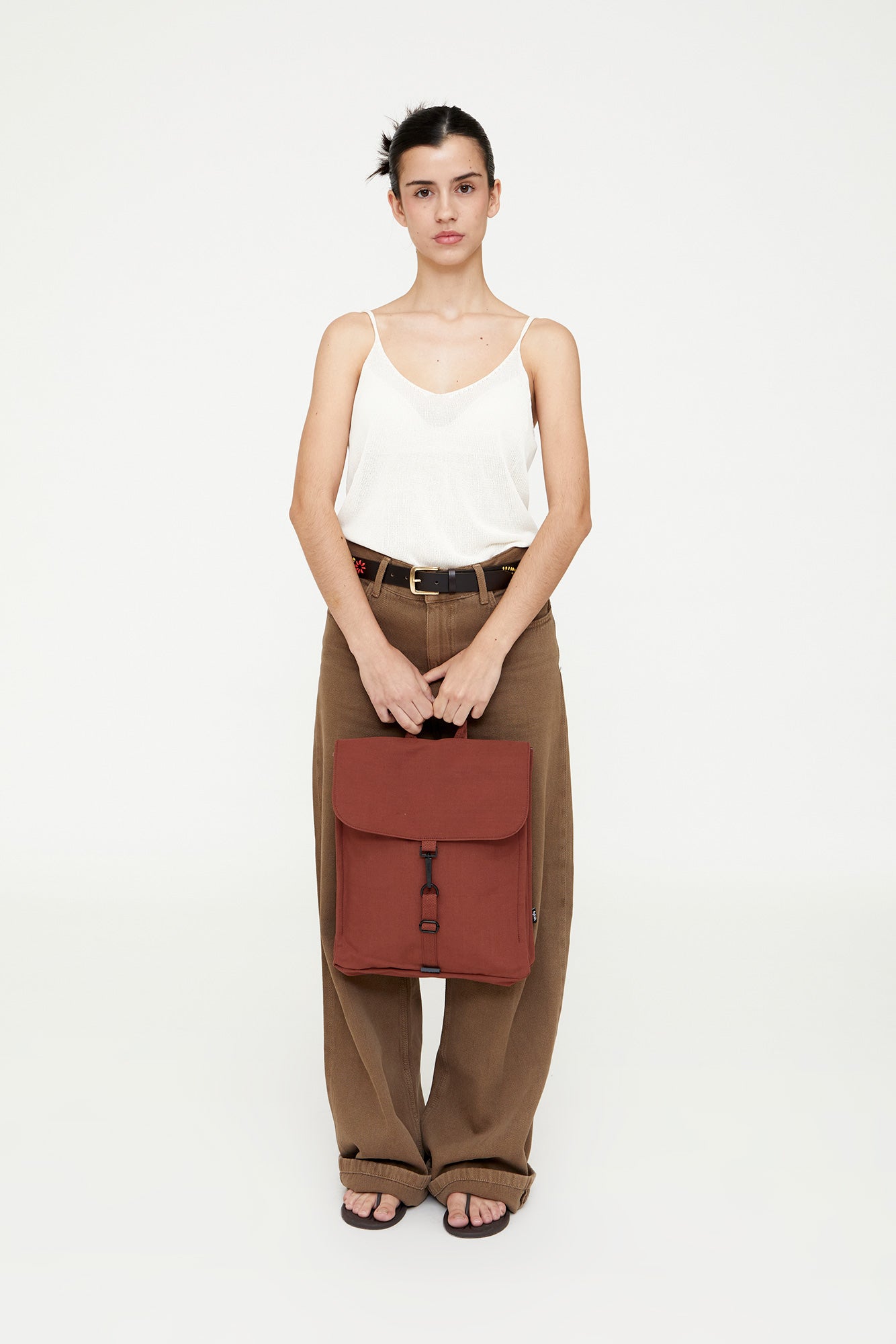 Woman holding a red bag against a white background