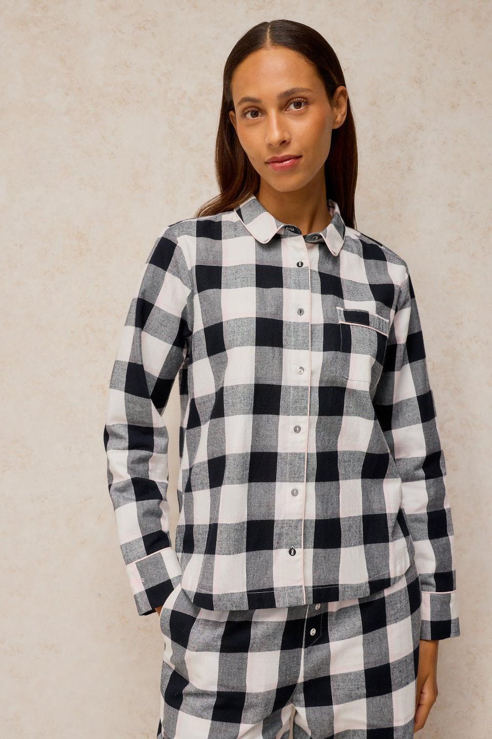 Woman posing in a black and white check organic cotton pyjama top.