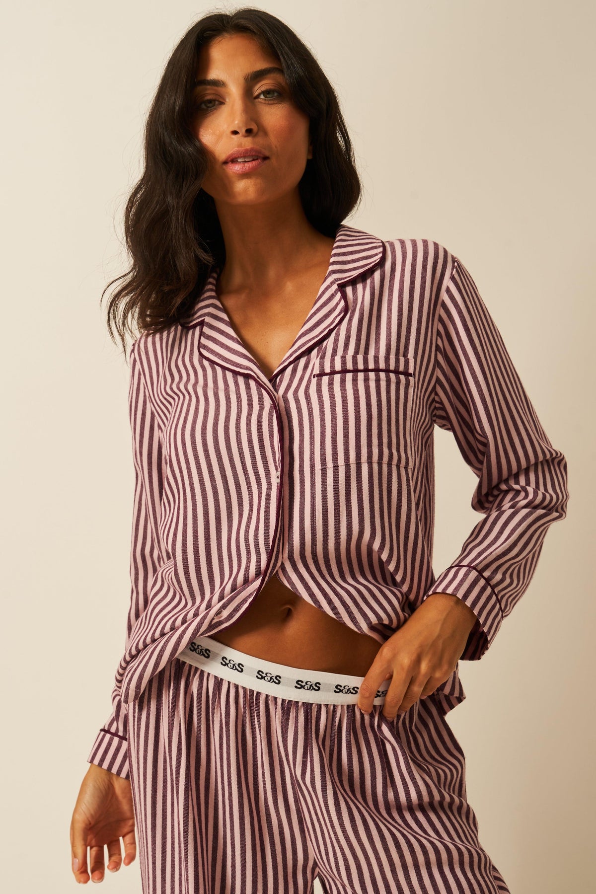 A woman modeling soft pink stripe Tencel pyjamas from Stripe & Stare