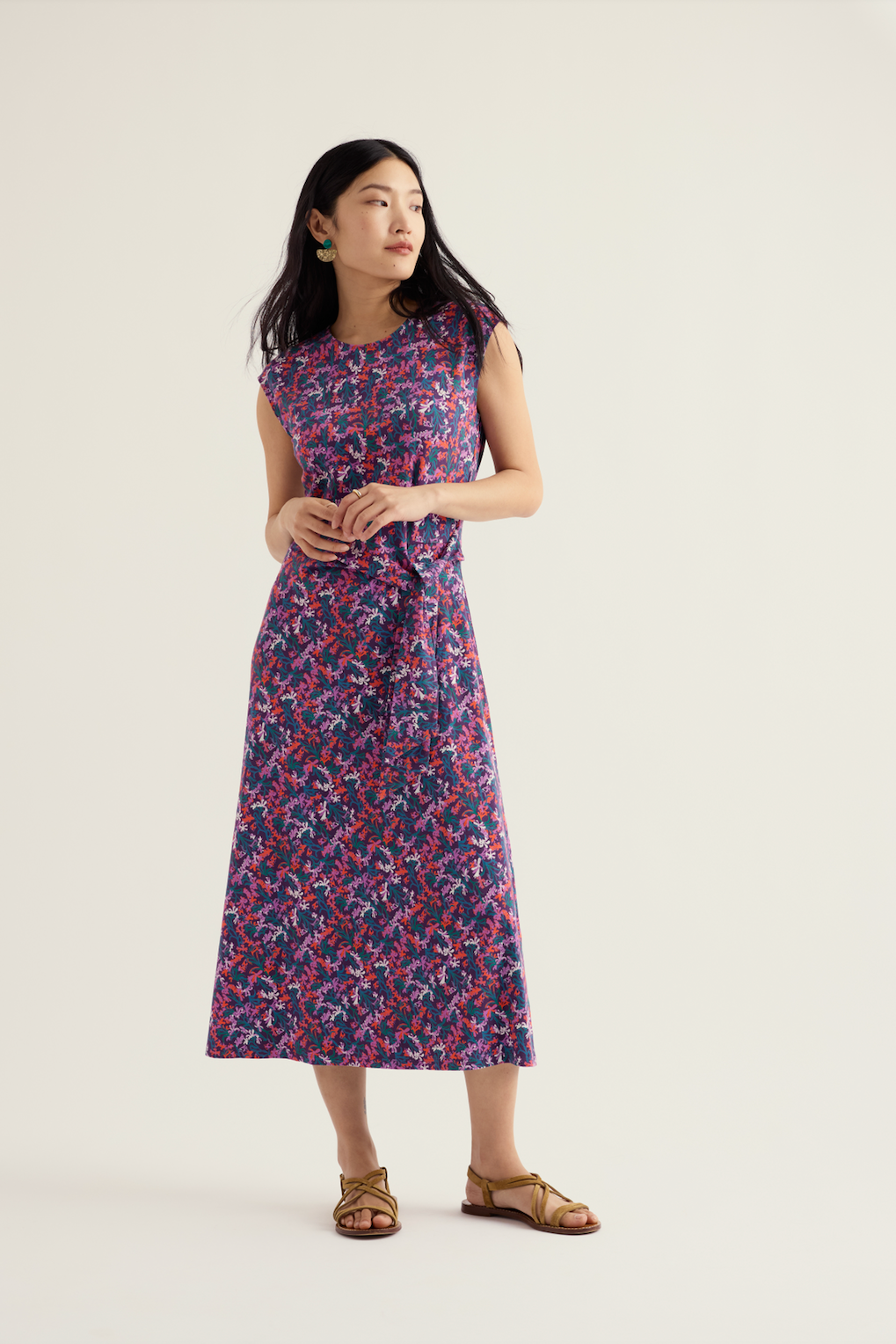 Woman modeling a Seasalt organic cotton floral print midi dress against a plain background.