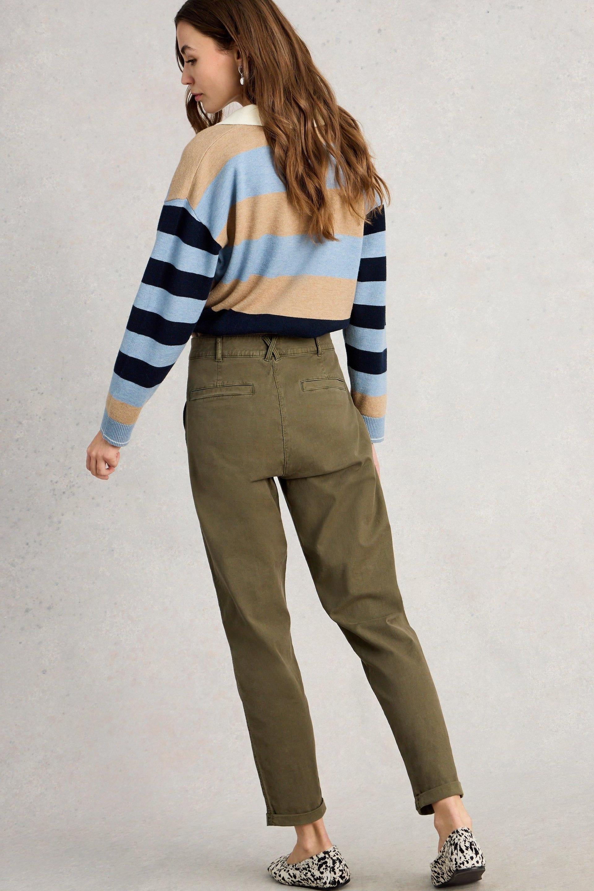 A woman from behind wearing khaki organic cotton White Stuff twister chino trousers and a striped sweater.