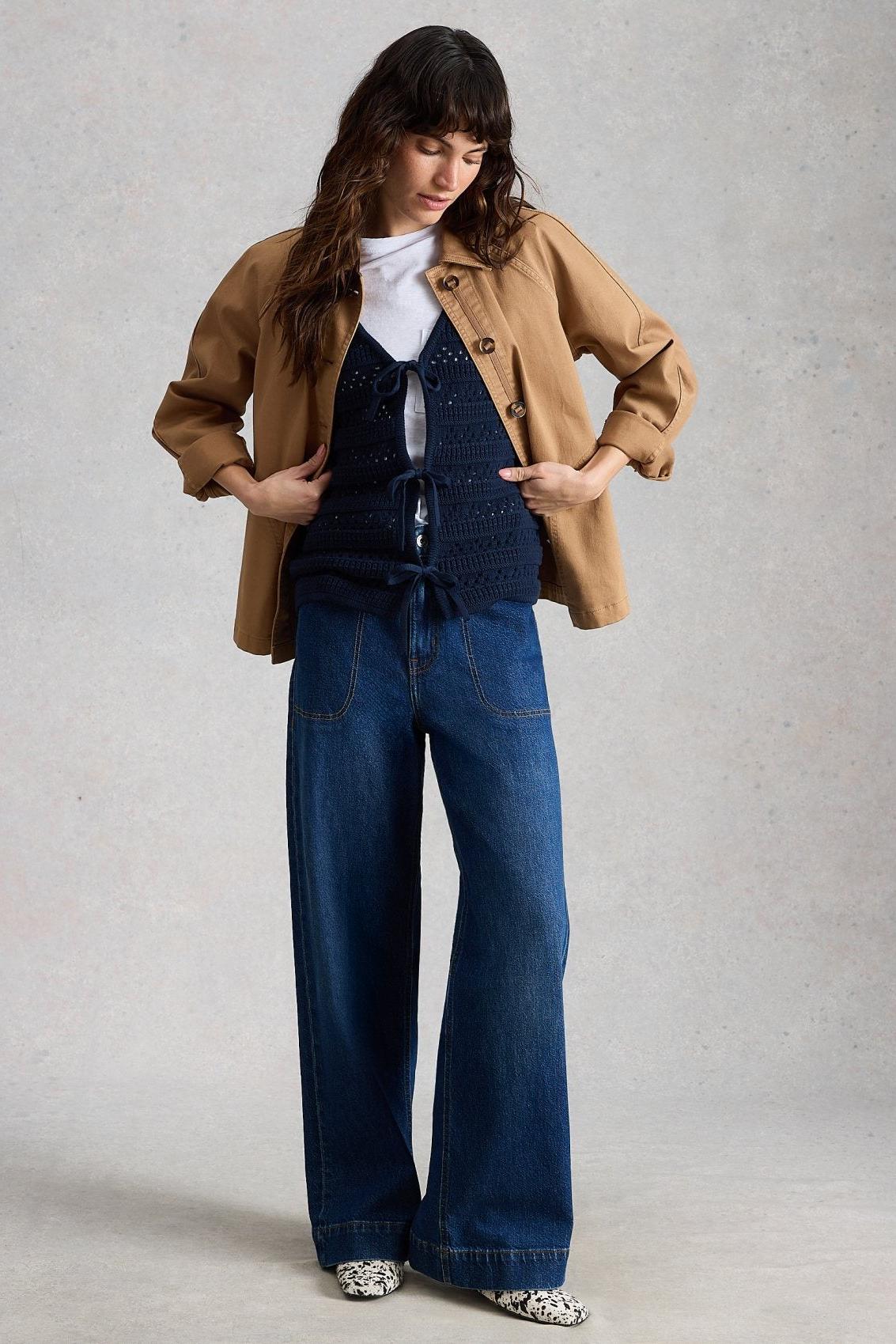 Woman modeling White Stuff wide leg casual denim jeans and a tan jacket