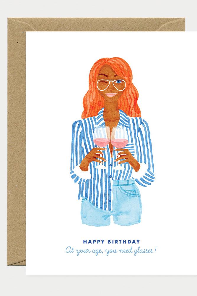 Greeting card with illustration of a woman holding drinks and text 'Happy Birthday, at your age, you need glasses!'