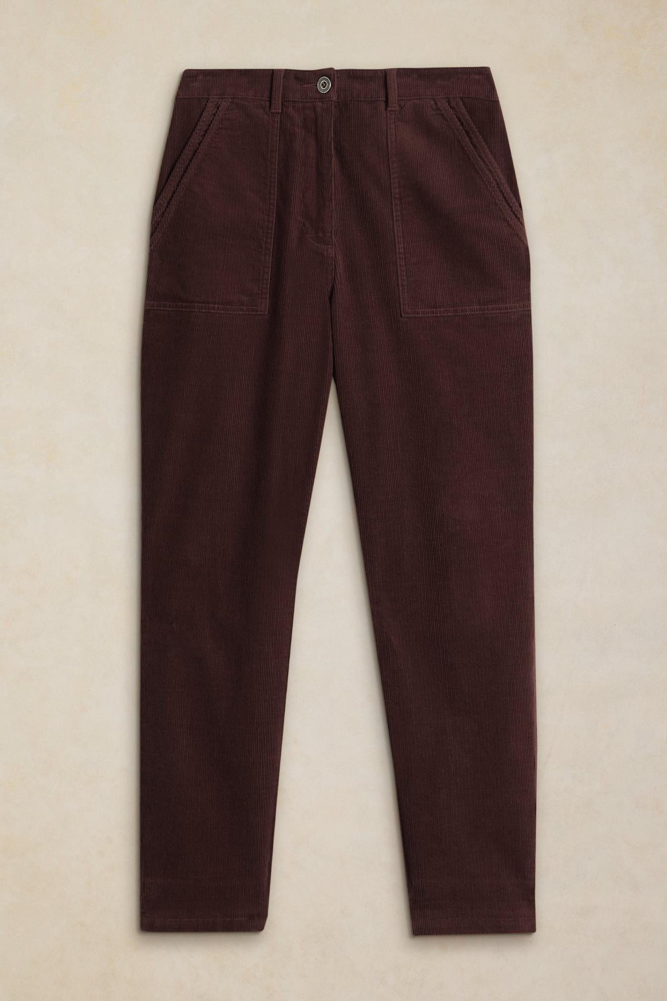 Women's brown organic cotton cord trousers with patch pockets, flat lay against a light neutral background.