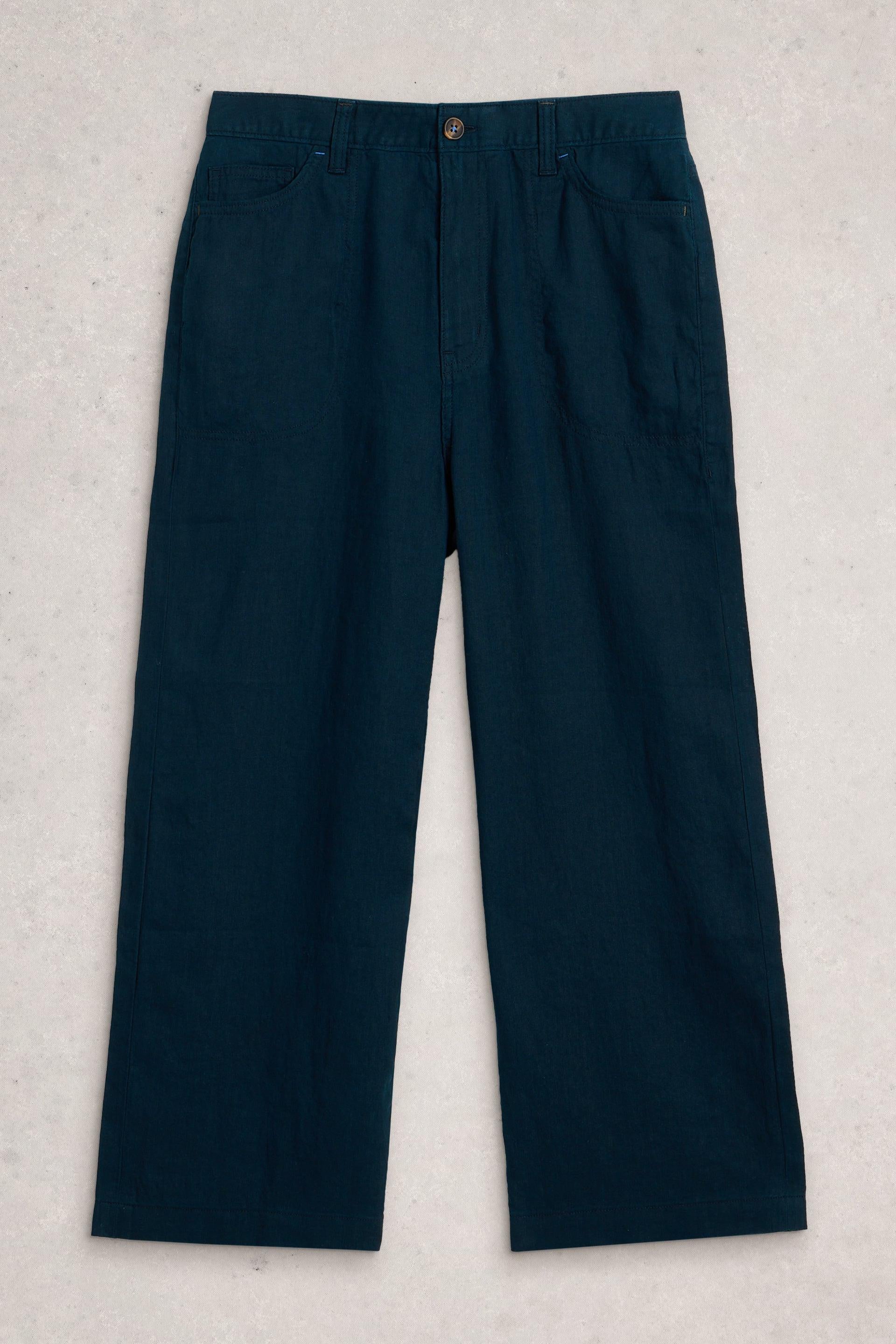 Navy wide leg linen trousers on a light gray background