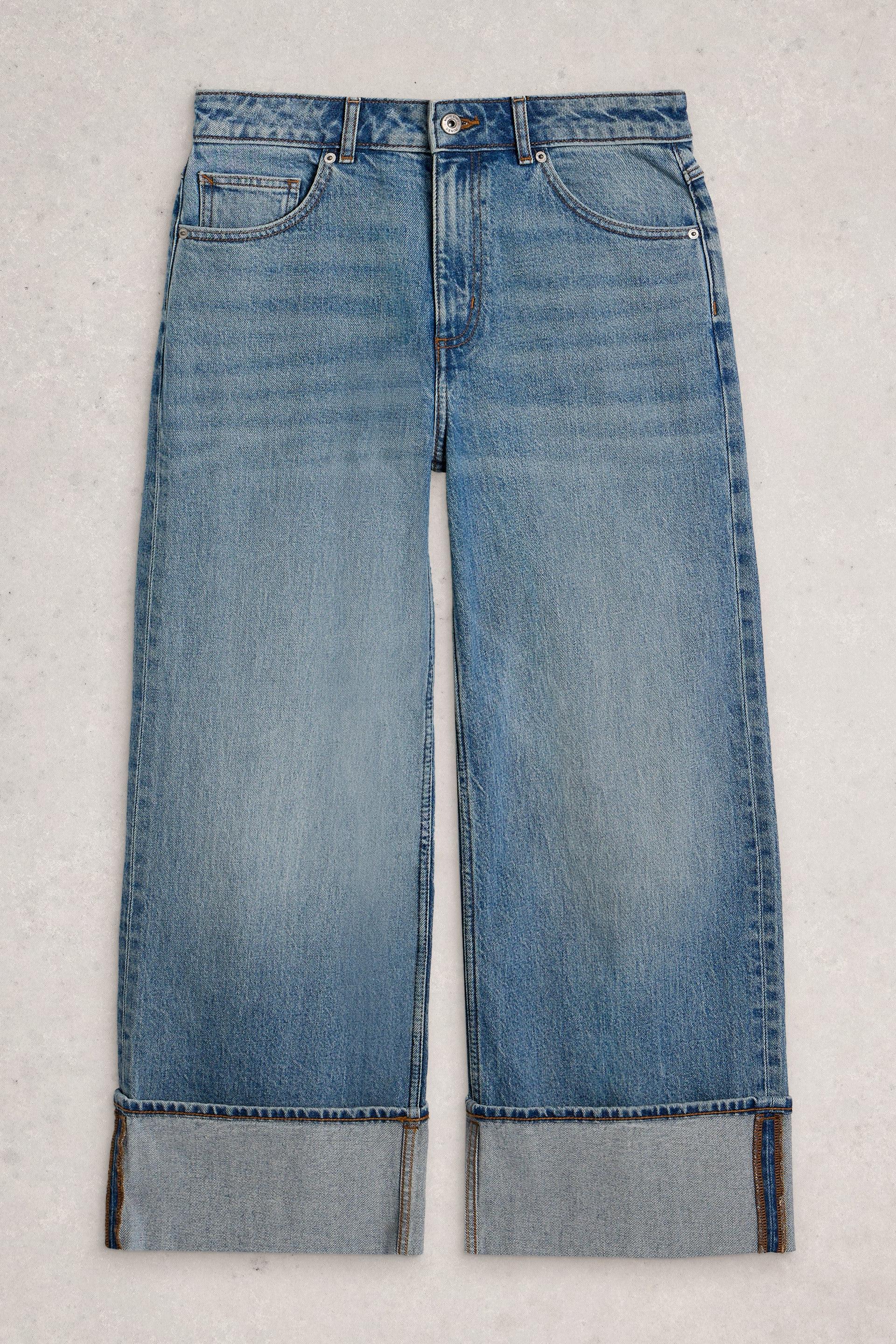 Pair of blue organic cotton jeans with a light wash on a white background 