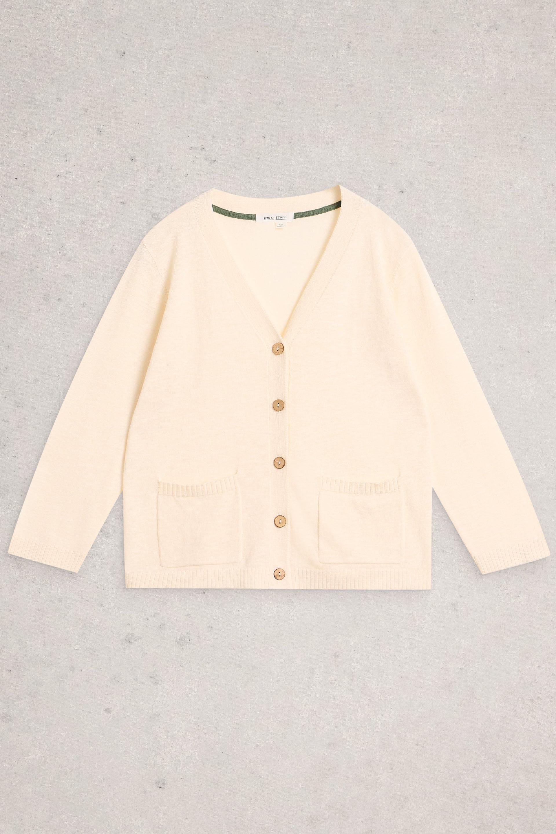 Cream White Stuff cardigan with buttons on a gray background