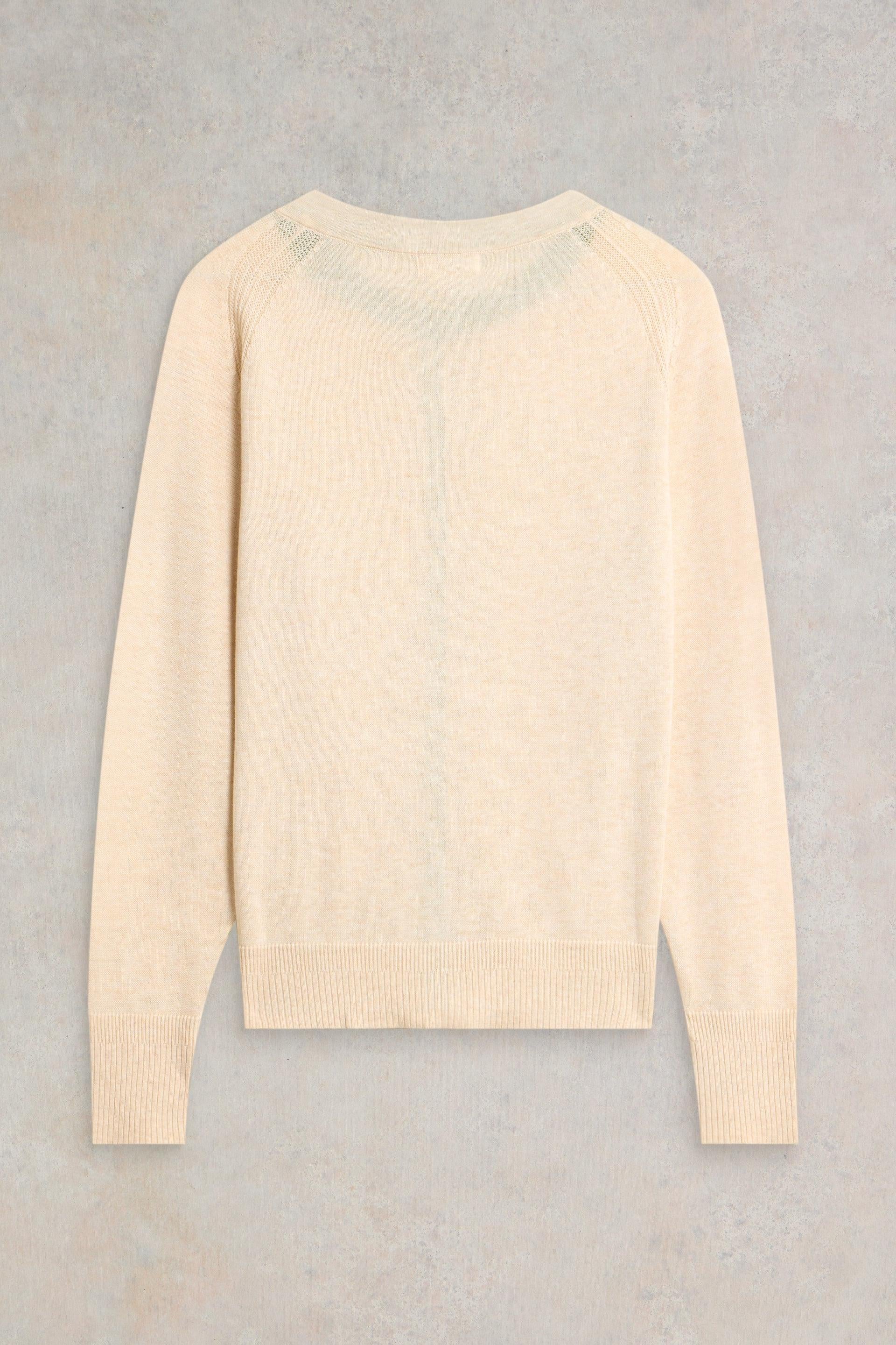 Beige White Stuff cardigan on a gray background
