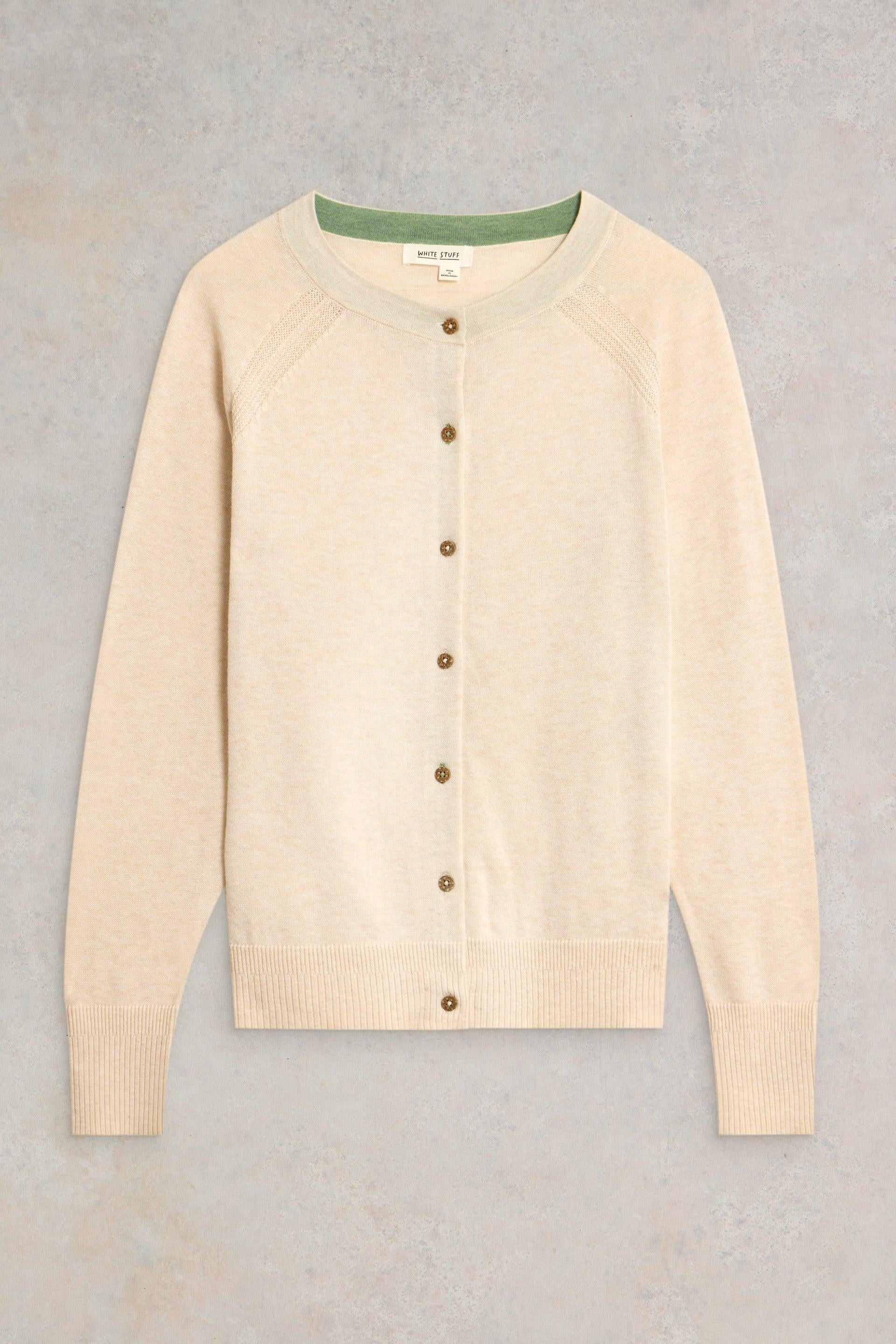 Beige organic cotton cardigan with brown buttons on a gray background