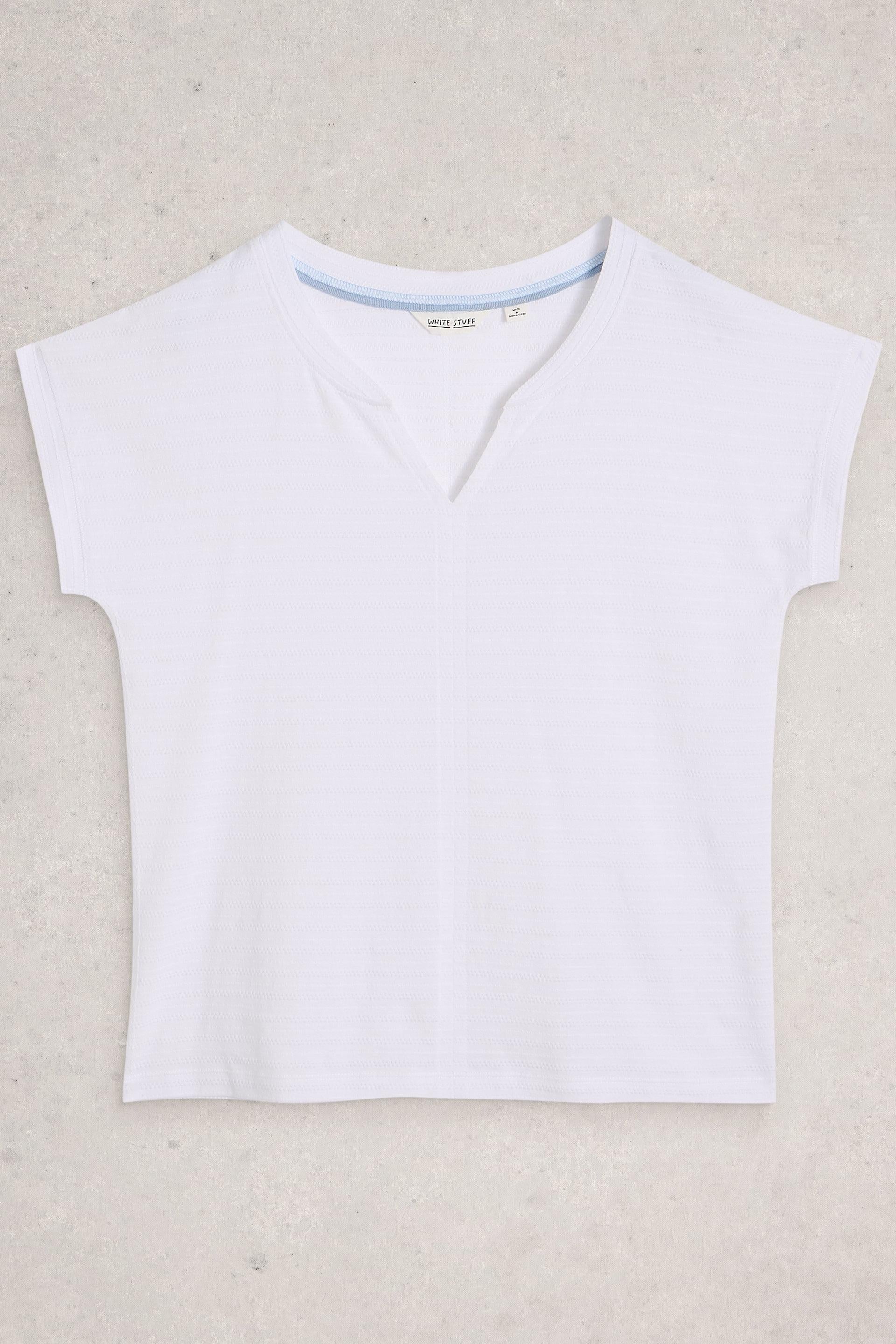 White sleeveless top on a beige background