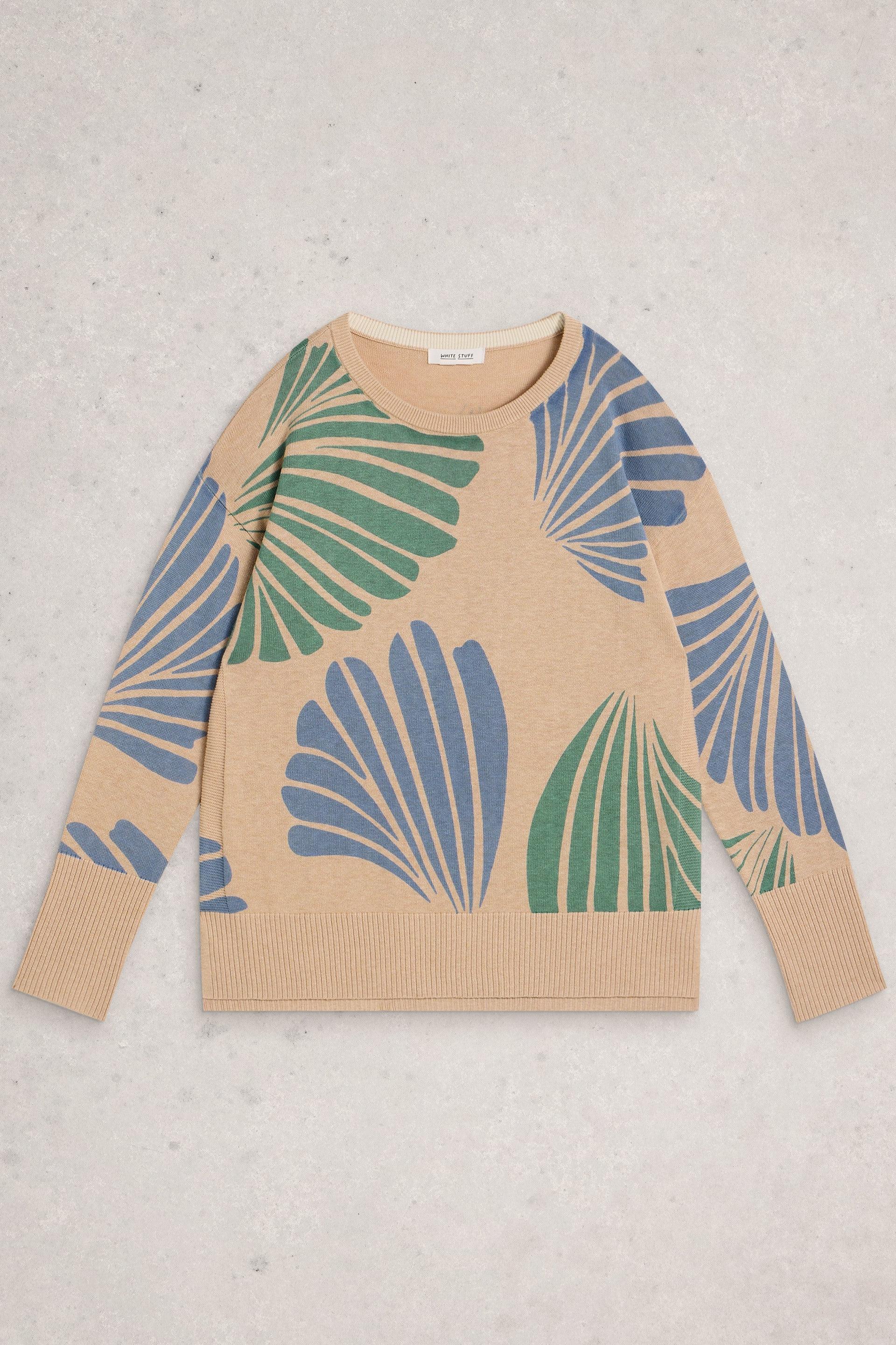 Beige White Stuff sweater with blue and green leaf pattern on a light gray background