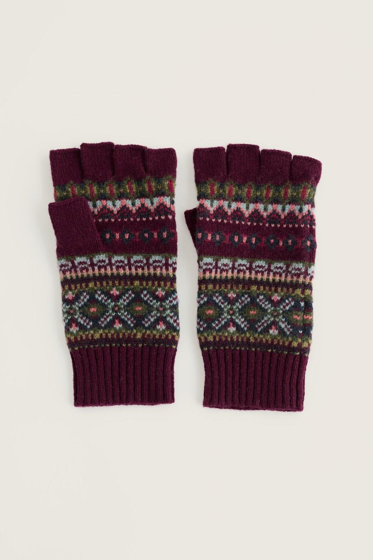 Pair of women's wool knit fingerless gloves with a decorative Fair Isle pattern in burgundy, green, and pink.