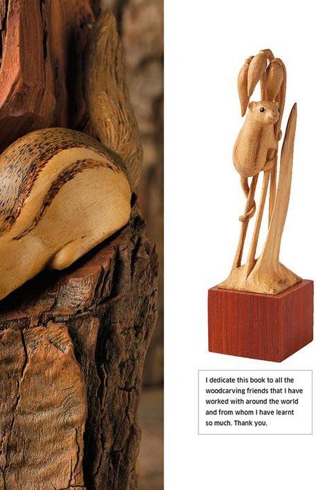 Wooden squirrel carving on a log with a book titled 'Contents' on the right.