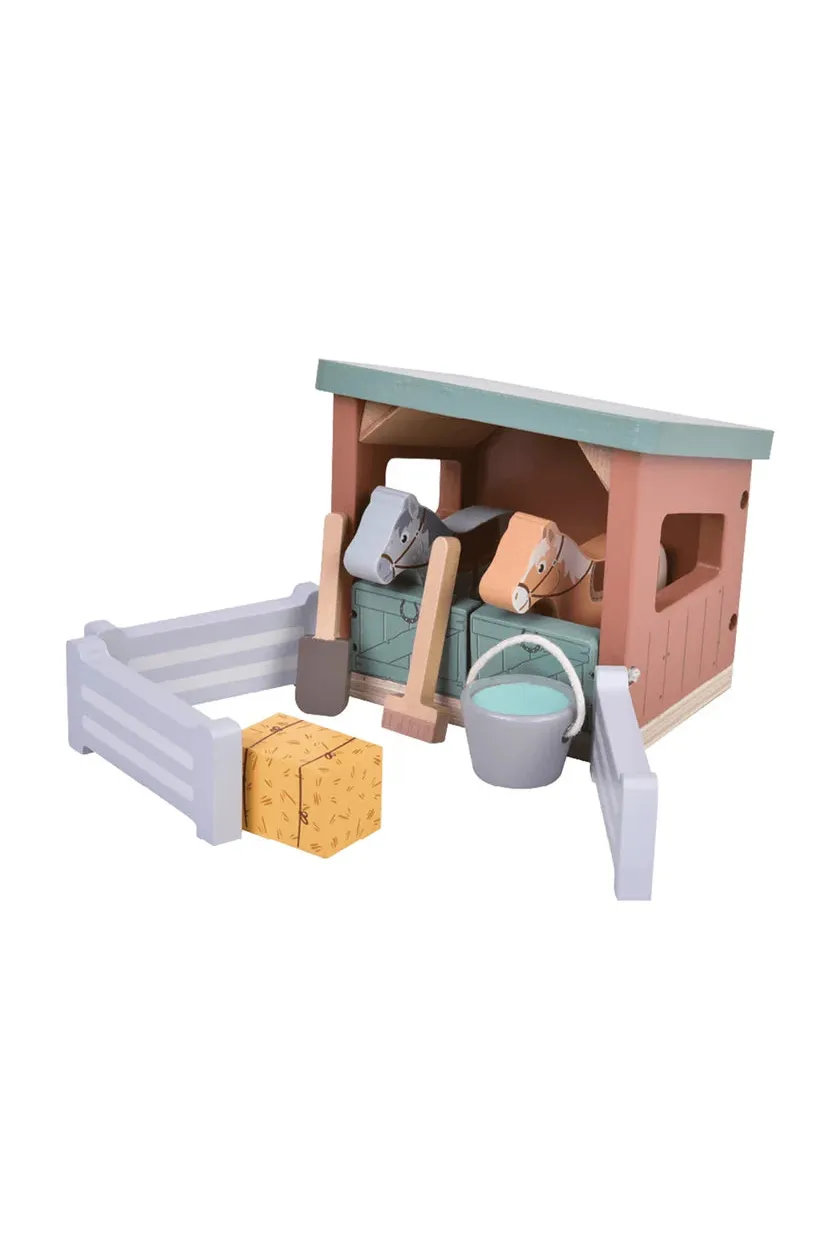 Children's toy stable with horses, hay, and accessories on a white background