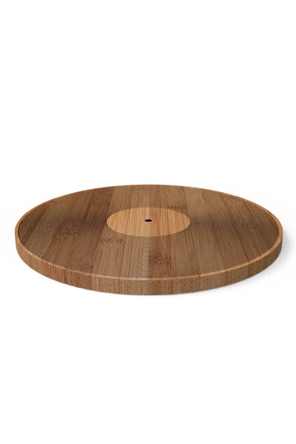 A round wooden serving board or tray with a natural wood grain pattern, featuring a lighter circular inset in the center and a small hole at the top, shown on a plain white background.