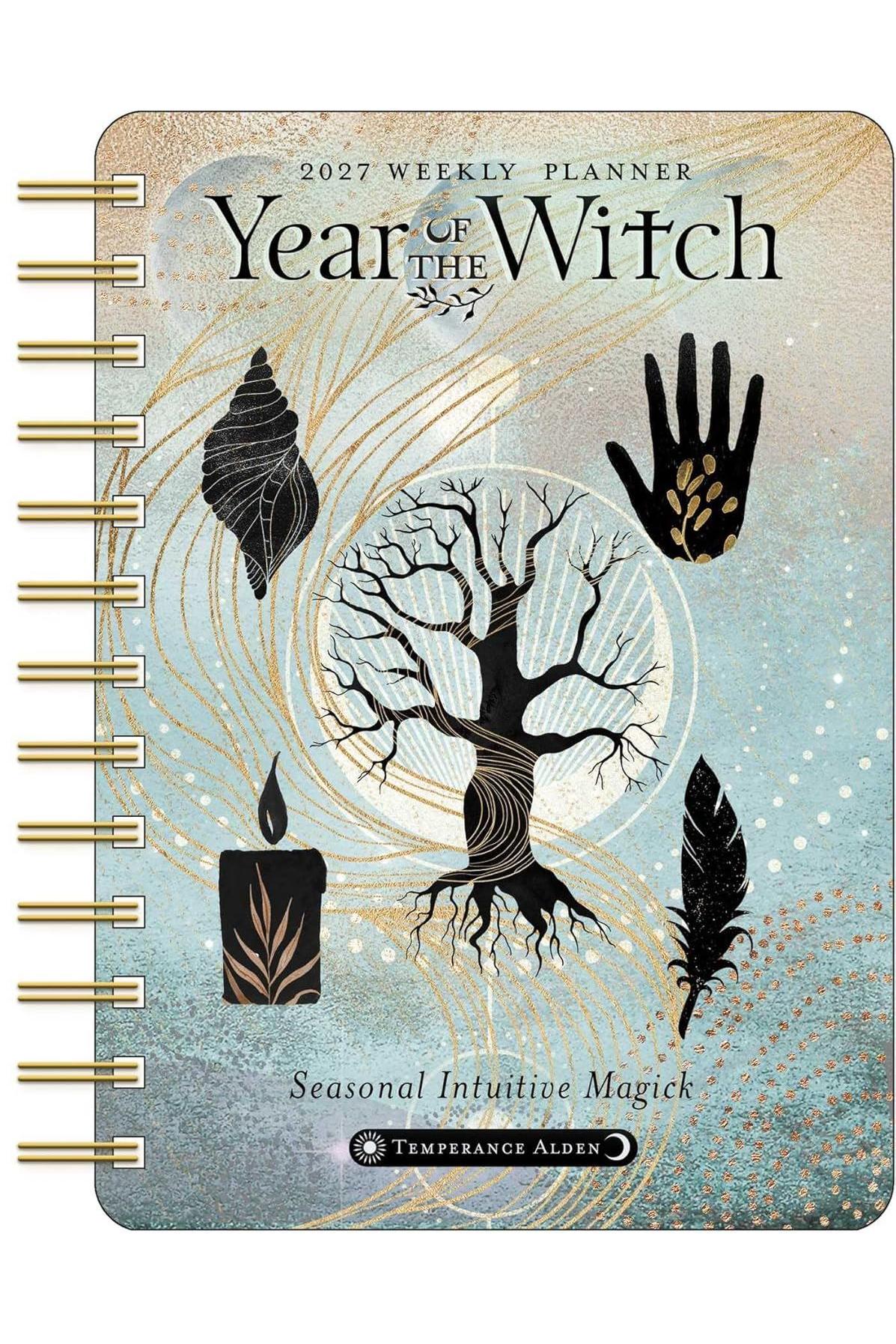 Year of the Witch 2027 weekly planner featuring a tree, seashell, candle, hand, and feather on a blue background.
