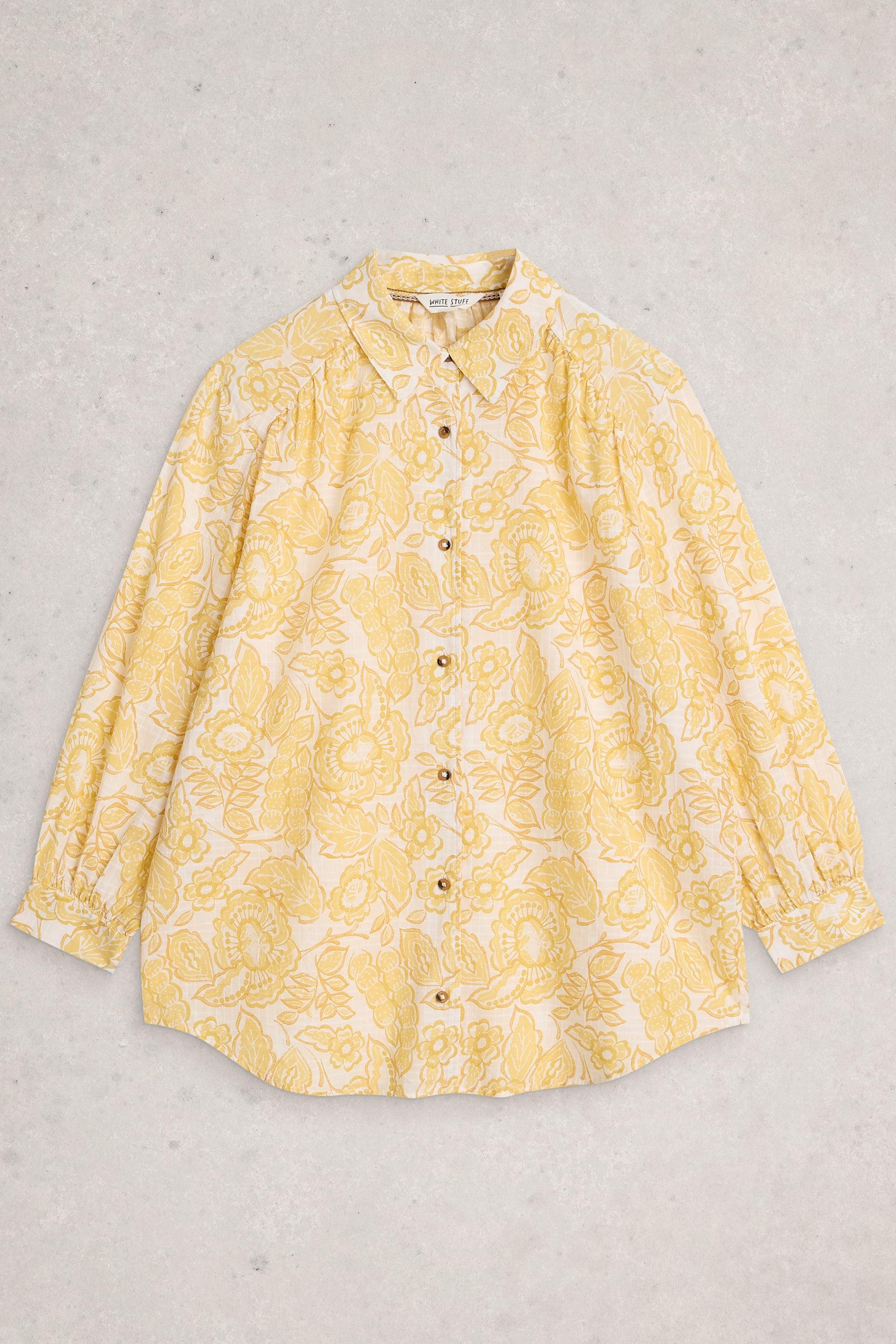 Yellow floral patterned shirt on a light gray background