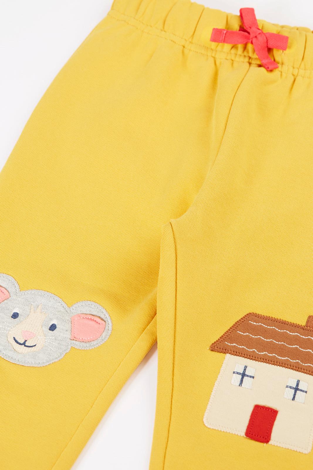 Bright yellow Frugi organic cotton joggers featuring mouse and house applique designs for girls.