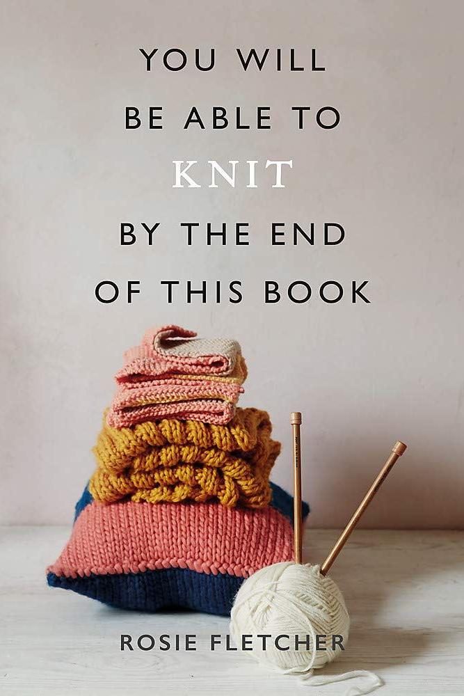 Book cover with knitting ball and needles with writing "you will be able to knit by the end of this book"
