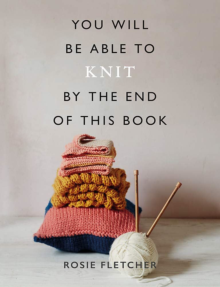 Book cover with knitting ball and needles with writing "you will be able to knit by the end of this book"