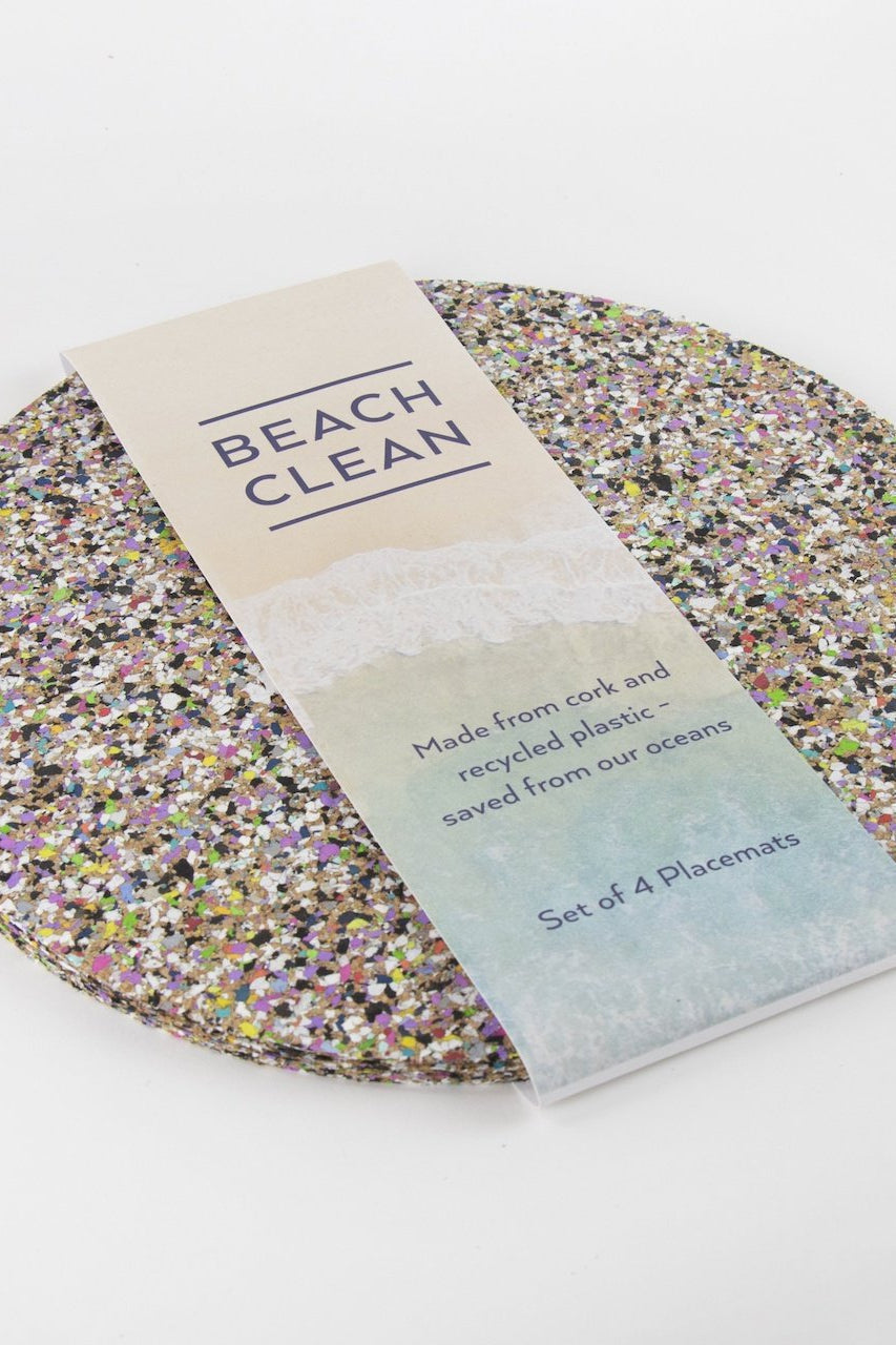 Set of four Liga Beach Clean Round Placemats with beach designed band.