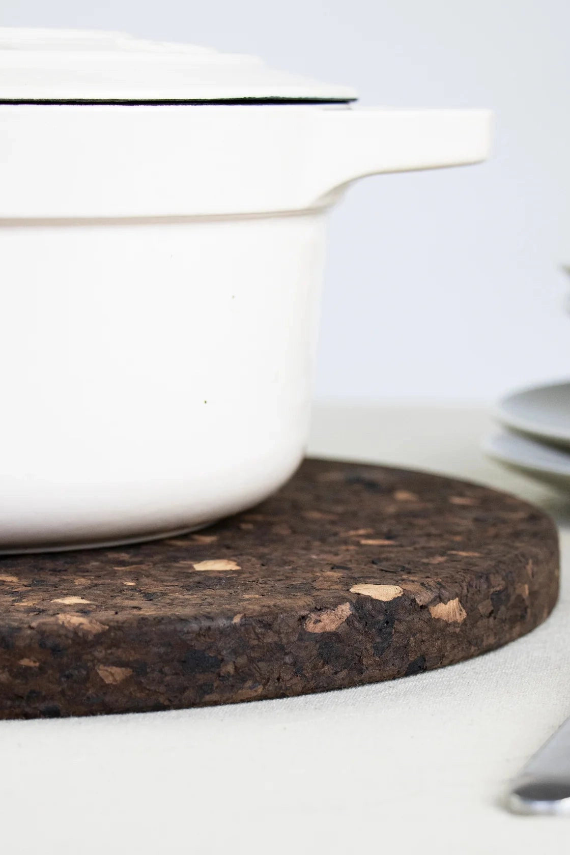 Close-up of the Liga Smoked Cork Trivet in use with pot on top.